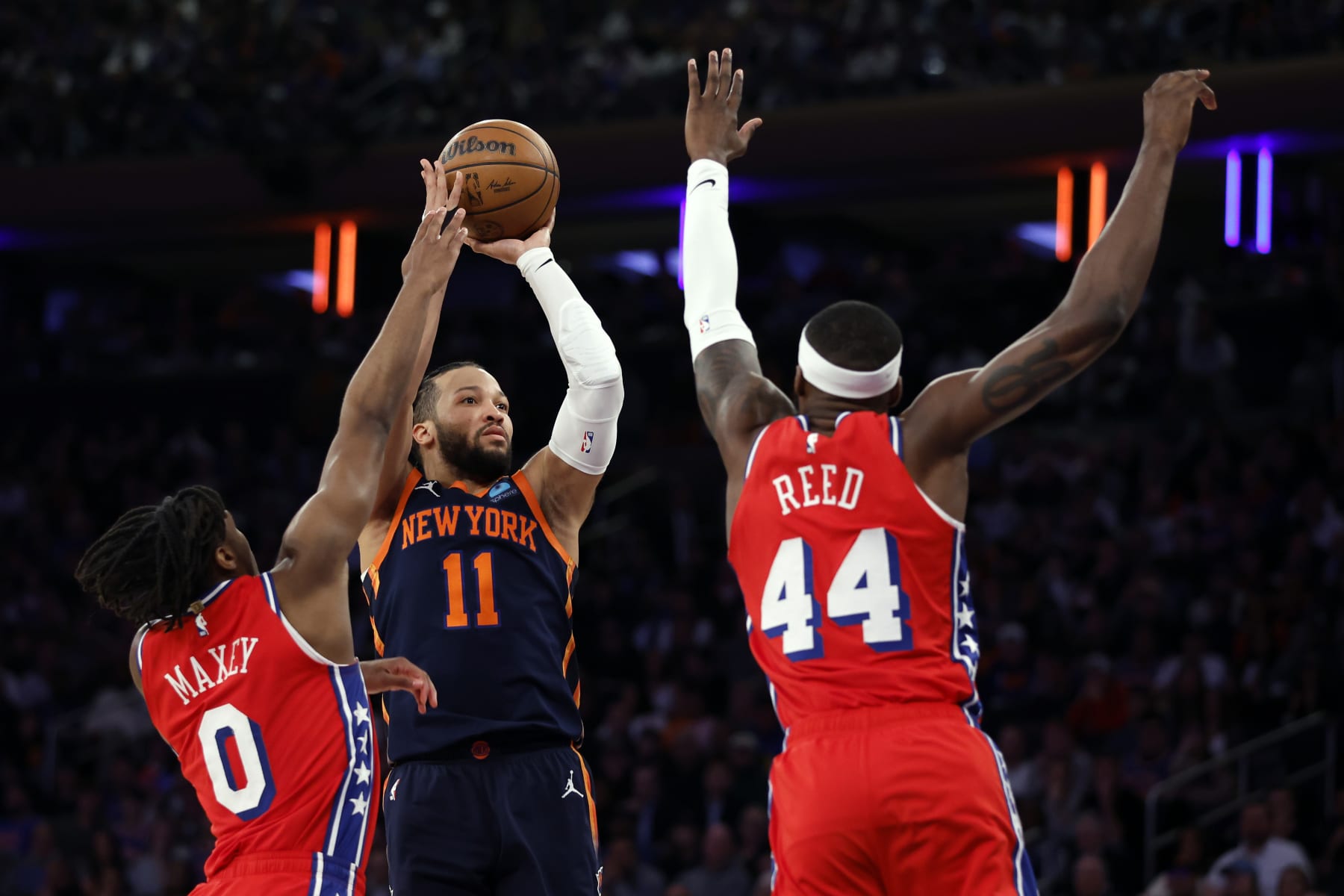 NEW YORK, NEW YORK - APRIL 22: Jalen Brunson #11 of the New York Knicks shoots the ball as Tyrese Maxey #0 and Paul Reed #44 of the Philadelphia 76ers defend during the second half in Game Two of the Eastern Conference First Round Playoffs at Madison Square Garden on April 22, 2024 in New York City. The Knicks won 104-101. NOTE TO USER: User expressly acknowledges and agrees that, by downloading and or using this photograph, User is consenting to the terms and conditions of the Getty Images License Agreement. (Photo by Sarah Stier/Getty Images)