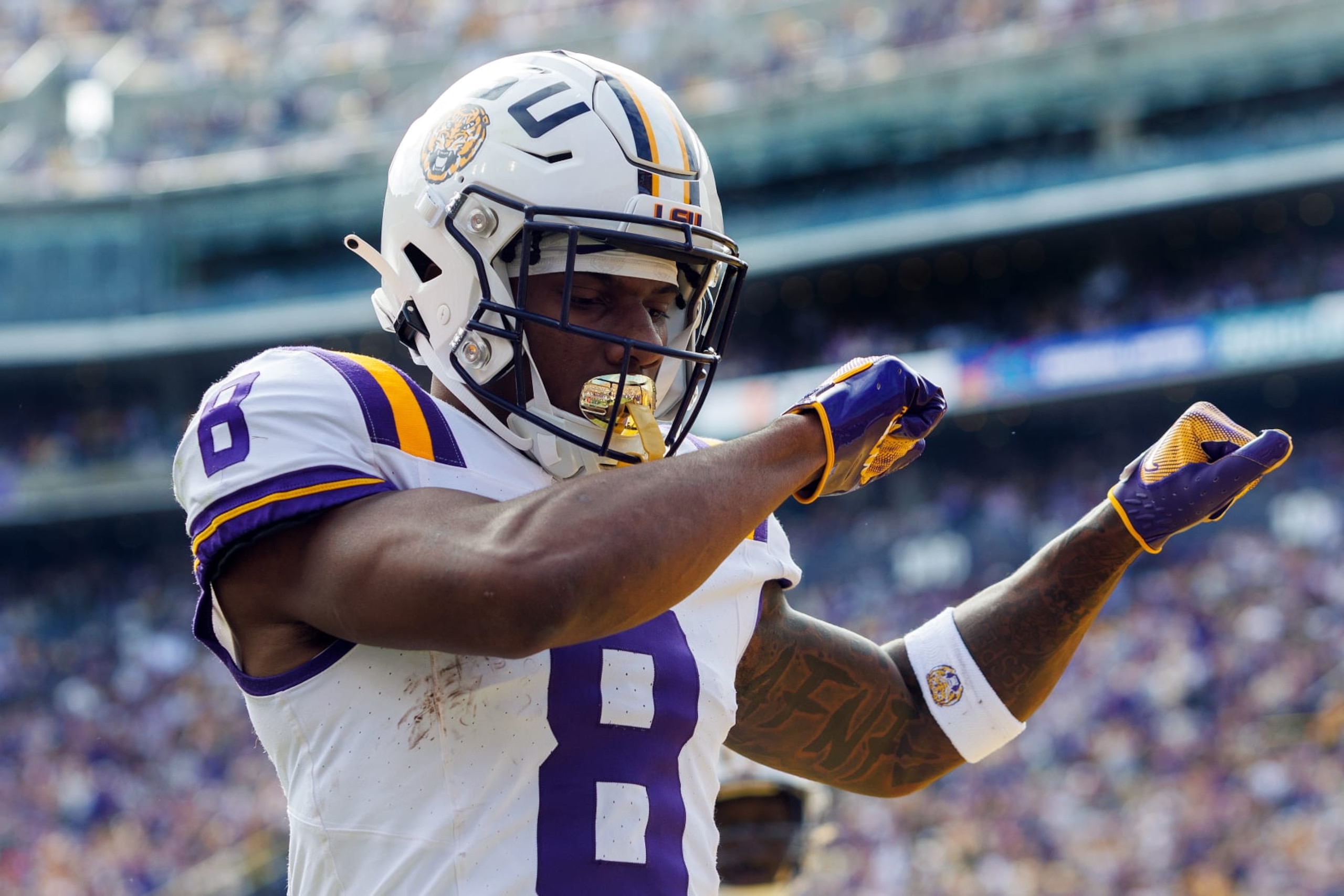 BATON ROUGE, LA - NOVEMBER 25: LSU Tigers wide receiver Malik Nabers (8) scores a touchdown during a game between the Texas A&M Aggies and the LSU Tigers on November 25, 2023, at Tiger Stadium in Baton Rouge, Louisiana. (Photo by John Korduner/Icon Sportswire via Getty Images)