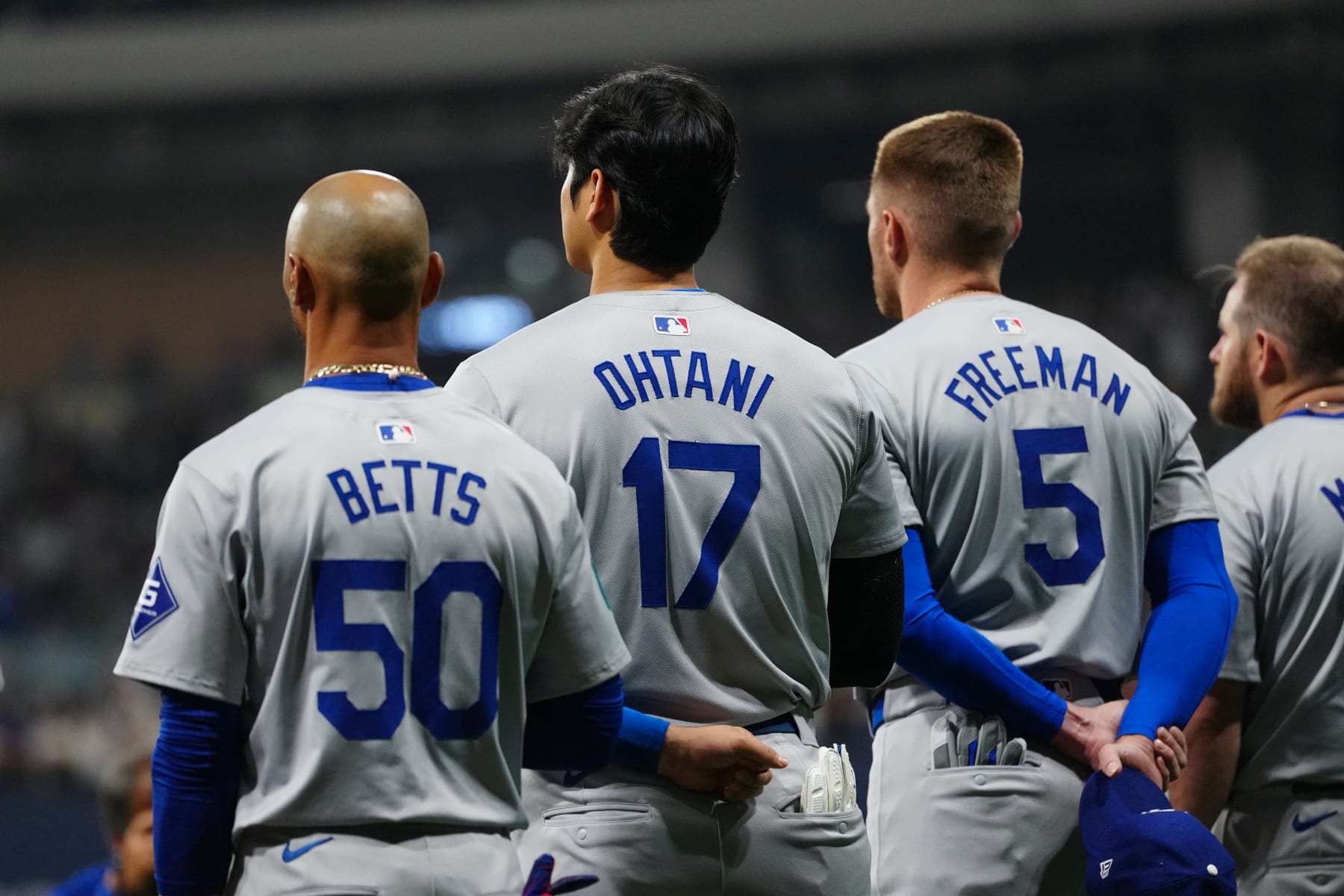 SEOUL, SOUTH KOREA - MARCH 20: Mookie Betts #50, Shohei Ohtani #17 and Freddie Freeman #5 of the Los Angeles Dodgers look on during the national anthem prior to the 2024 Seoul Series game between the Los Angeles Dodgers and the San Diego Padres at Gocheok Sky Dome on Wednesday, March 20, 2024 in Seoul, California. (Photo by Mary DeCicco/MLB Photos via Getty Images)