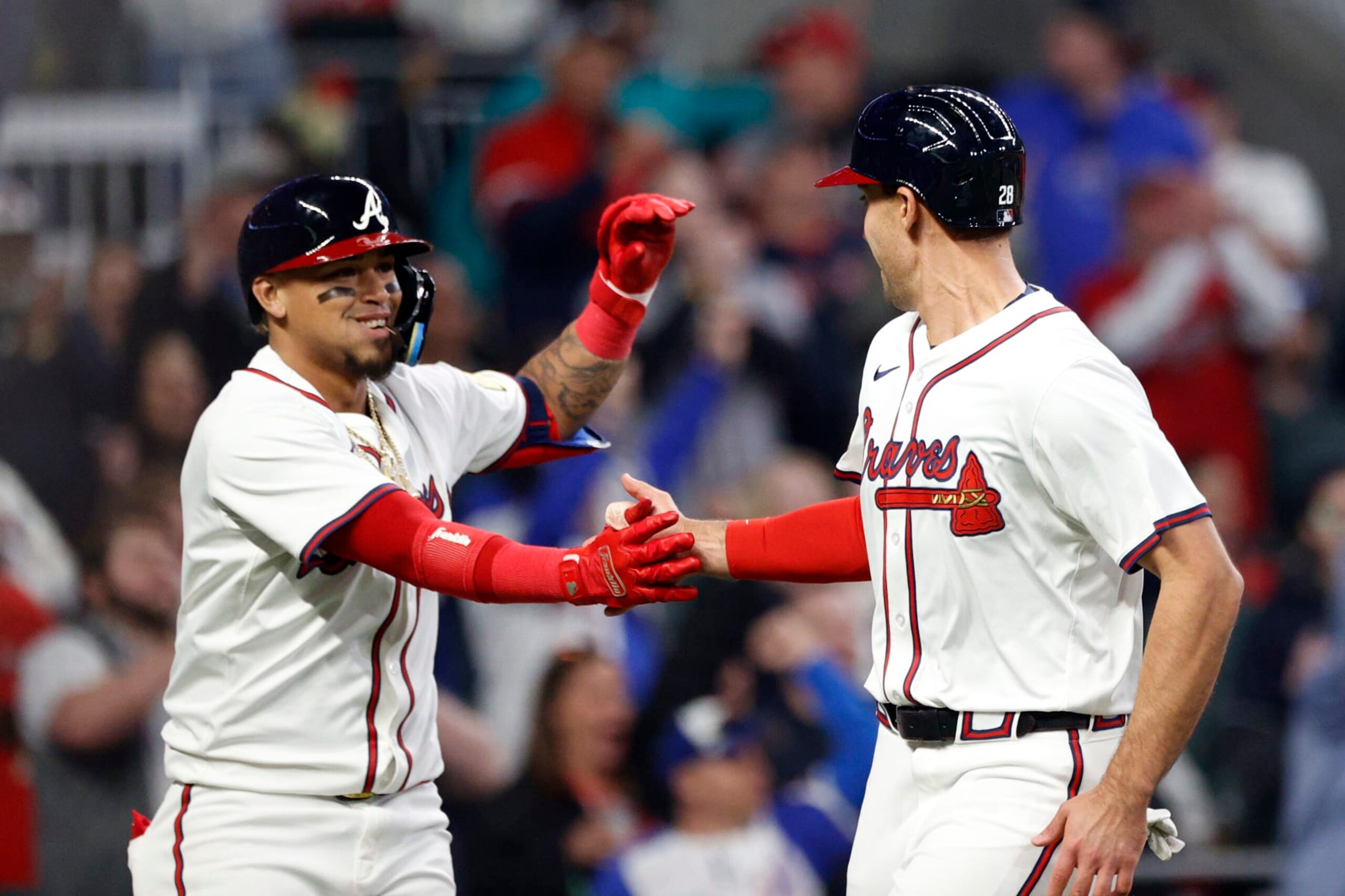 ATLANTA, GA - APRIL 06: Atlanta Braves first baseman Matt Olson #28 is congratulated by Atlanta Braves shortstop Orlando Arcia #11 after scoring a run during the MLB game between the Arizona Diamondbacks and the Atlanta Braves on April 6, 2024 at TRUIST Park in Atlanta, GA. (Photo by Jeff Robinson/Icon Sportswire via Getty Images)