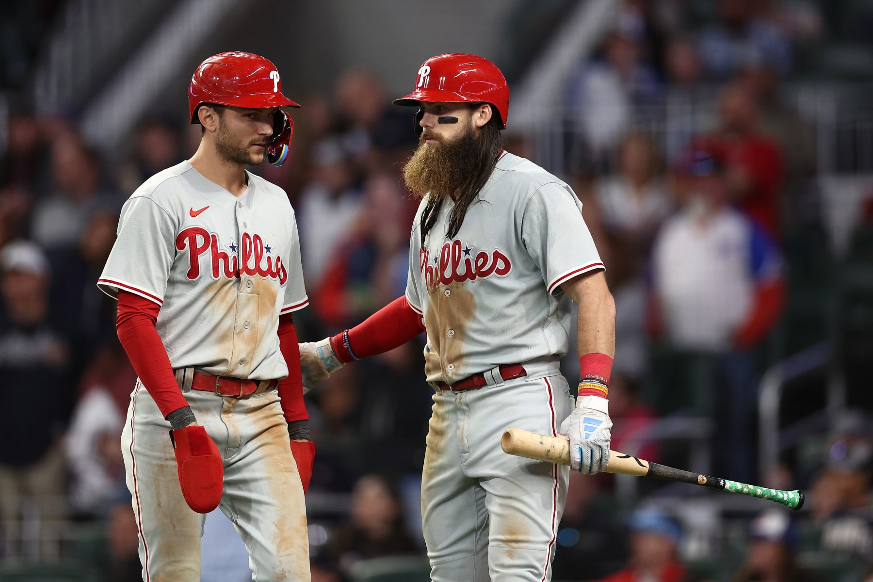 ATLANTA, GEORGIA - OCTOBER 07: Trea Turner #7 and Brandon Marsh #16 of the Philadelphia Phillies react after Turner scores a run during the eighth inning against the Atlanta Braves during Game One of the Division Series at Truist Park on October 07, 2023 in Atlanta, Georgia. (Photo by Elsa/Getty Images)