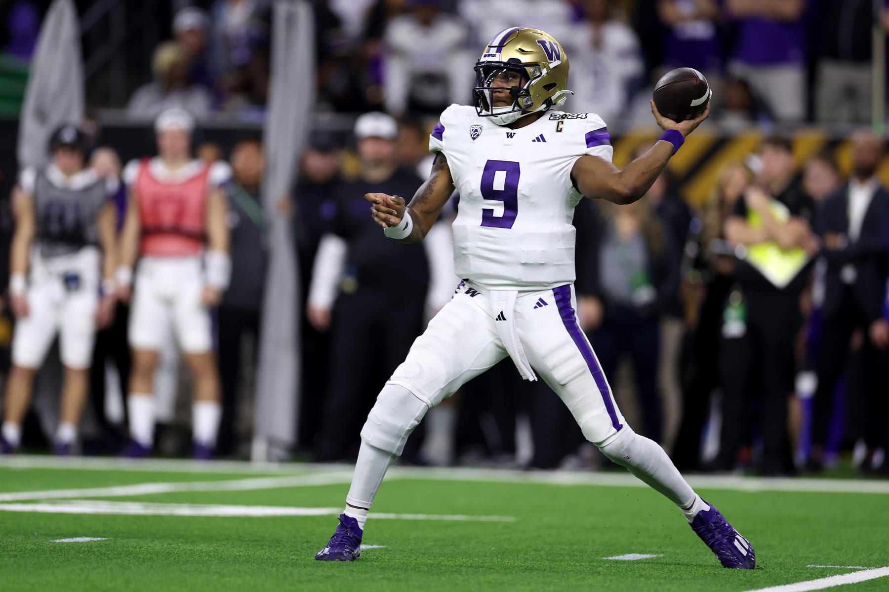 HOUSTON, TEXAS - JANUARY 08:  Michael Penix Jr. #9 of the Washington Huskies throws the ball in the first quarter against the Michigan Wolverines during the 2024 CFP National Championship game at NRG Stadium on January 08, 2024 in Houston, Texas. (Photo by Maddie Meyer/Getty Images)