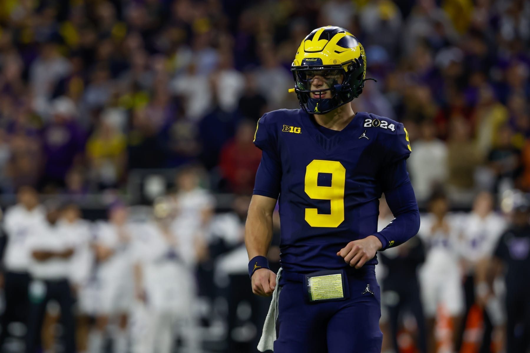 HOUSTON, TX - JANUARY 08: Michigan Wolverines quarterback J.J. McCarthy (9) looks to the sideline for the play call during the CFP National Championship game Michigan Wolverines and Washington Huskies on January 8, 2024, at NRG Stadium in Houston, Texas. (Photo by David Buono/Icon Sportswire via Getty Images)