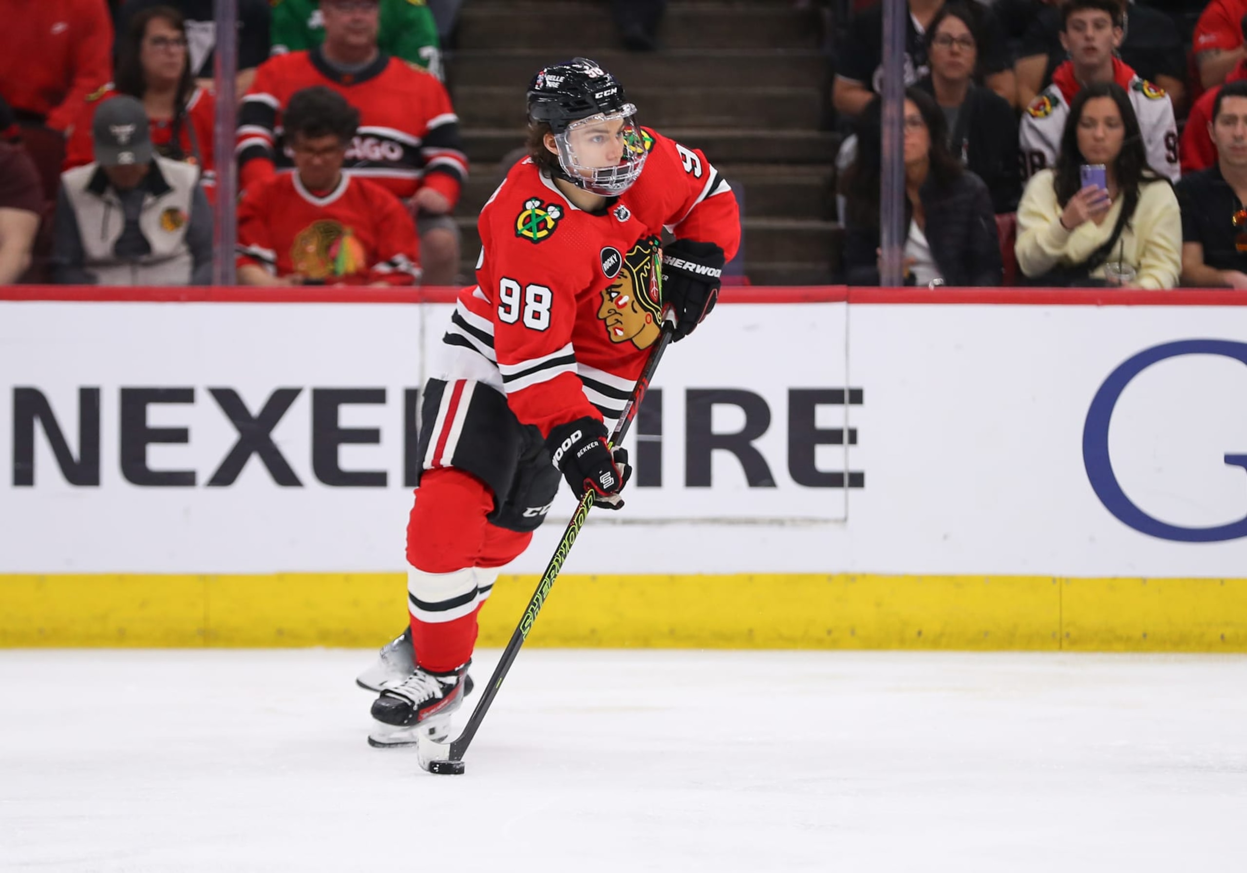CHICAGO, IL - APRIL 14: Connor Bedard #98 of the Chicago Blackhawks controls the puck during the third period against the Carolina Hurricanes at the United Center on April 14, 2024 in Chicago, Illinois. (Photo by Melissa Tamez/Icon Sportswire via Getty Images)