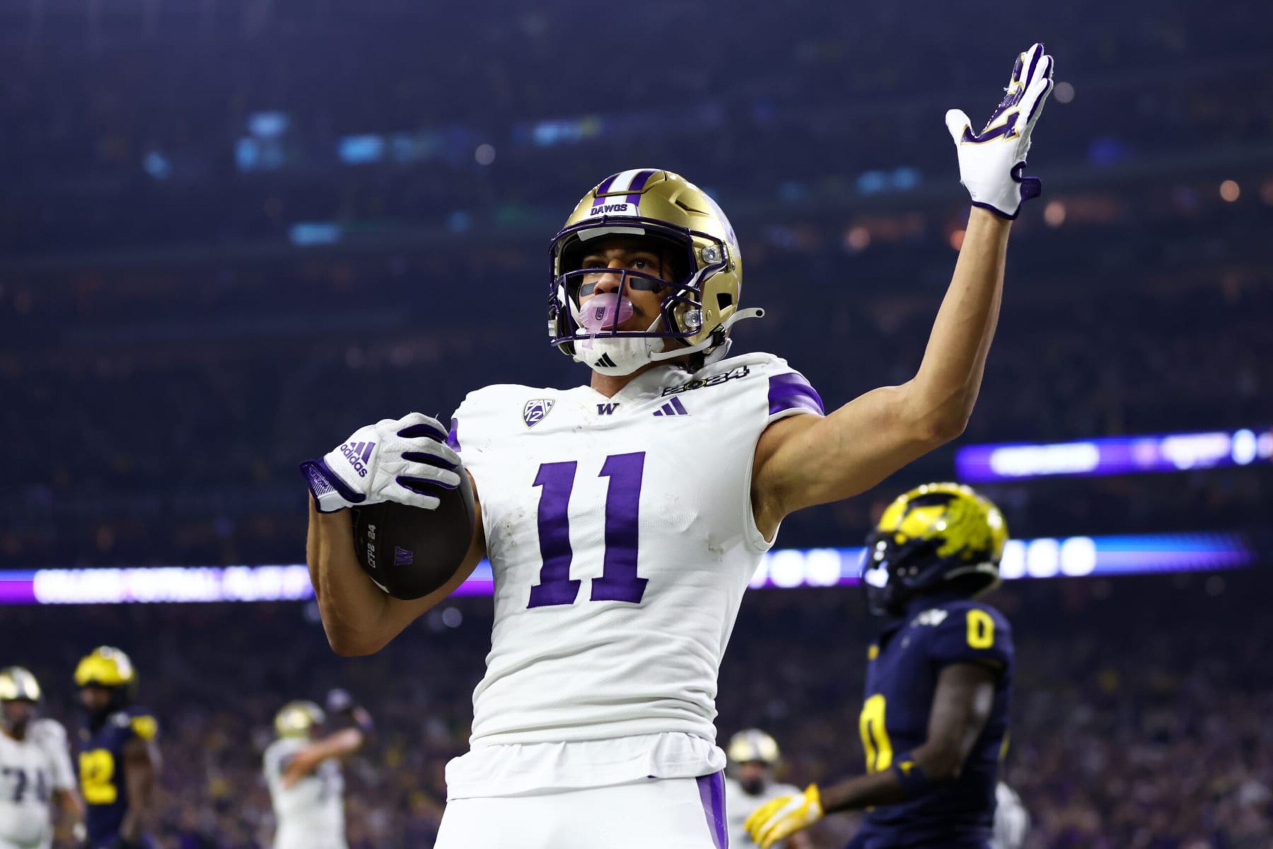 HOUSTON, TEXAS - JANUARY 08: Jalen McMillan #11 of the Washington Huskies celebrates after catching a pass for a touchdown against Mike Sainristil #0 of the Michigan Wolverines in the second quarter during the 2024 CFP National Championship game at NRG Stadium on January 08, 2024 in Houston, Texas. (Photo by Maddie Meyer/Getty Images) HOUSTON, TEXAS - JANUARY 08: Jalen McMillan #11 of the Washington Huskies celebrates after catching a pass for a touchdown against Mike Sainristil #0 of the Michigan Wolverines in the second quarter during the 2024 CFP National Championship game at NRG Stadium on January 08, 2024 in Houston, Texas. (Photo by Maddie Meyer/Getty Images)