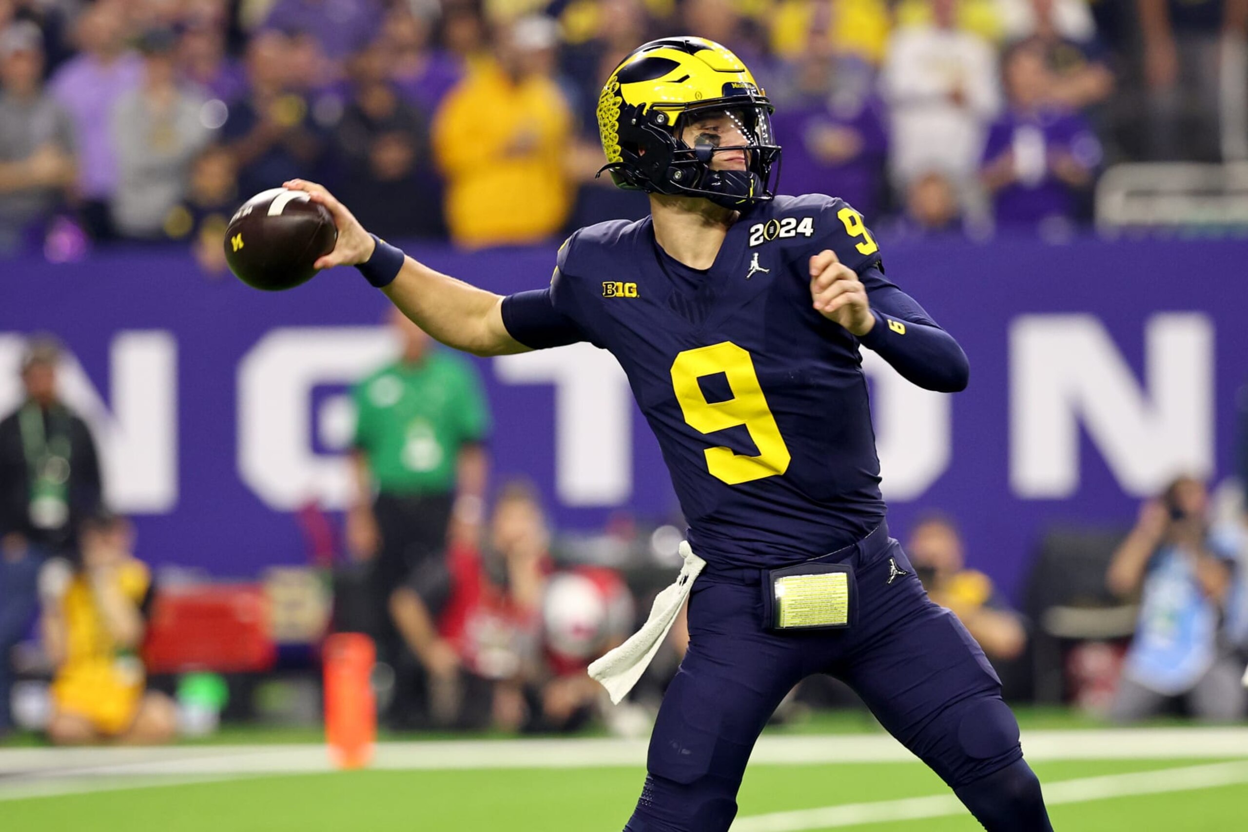 HOUSTON, TEXAS - JANUARY 8: J.J. McCarthy #9 of the Michigan Wolverines passes against the Washington Huskies during the 2024 CFP National Championship game at NRG Stadium on January 8, 2024 in Houston, Texas. (Photo by Jamie Schwaberow/Getty Images) HOUSTON, TEXAS - JANUARY 8: J.J. McCarthy #9 of the Michigan Wolverines passes against the Washington Huskies during the 2024 CFP National Championship game at NRG Stadium on January 8, 2024 in Houston, Texas. (Photo by Jamie Schwaberow/Getty Images)