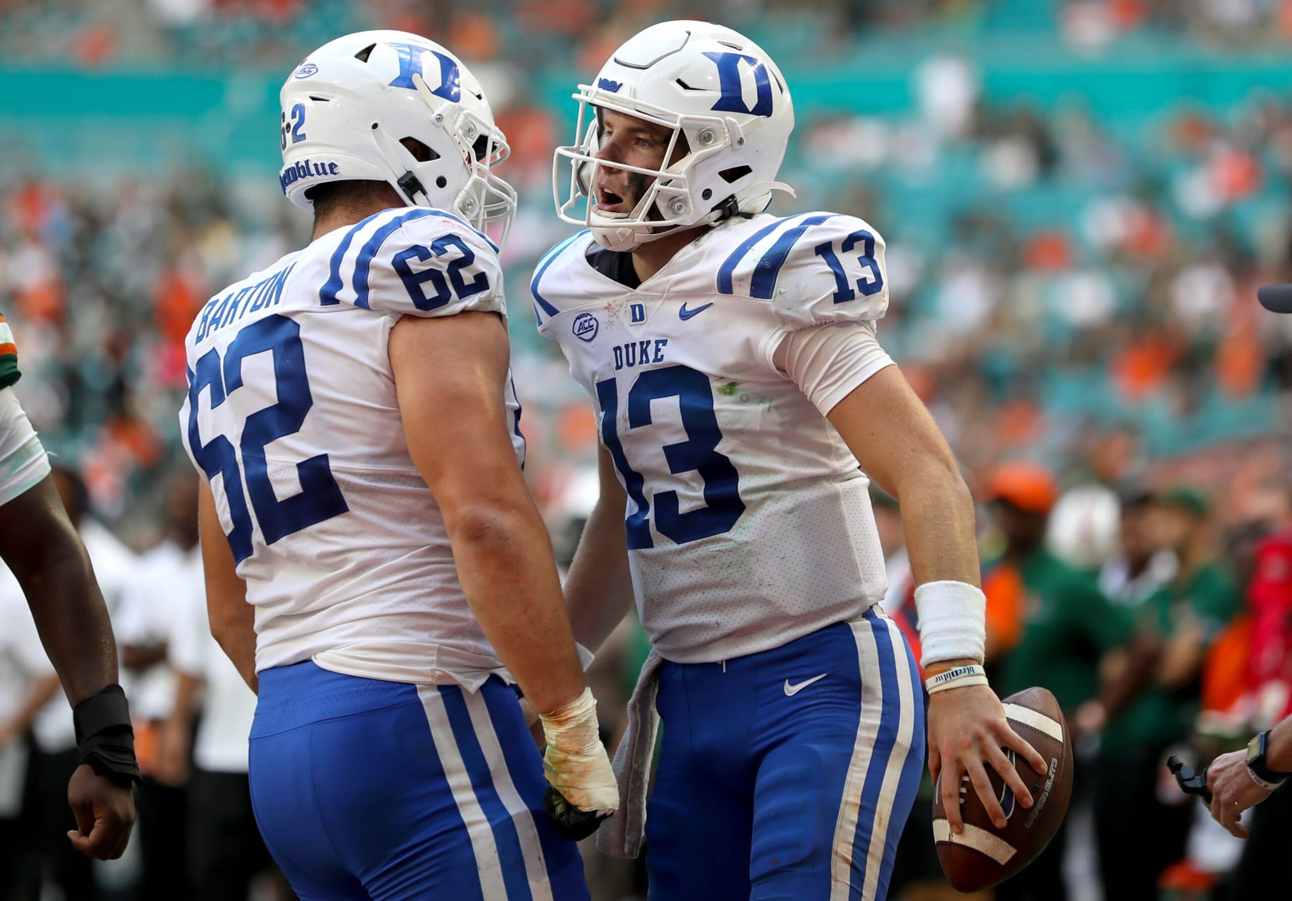 MIAMI GARDENS, FLORIDA - OCTOBER 22: Riley Leonard #13 of the Duke Blue Devils celebrates his second quarter touchdown against the Miami Hurricanes with teammate Graham Barton #62 of the Duke Blue Devils at Hard Rock Stadium on October 22, 2022 in Miami Gardens, Florida. (Photo by Megan Briggs/Getty Images) MIAMI GARDENS, FLORIDA - OCTOBER 22: Riley Leonard #13 of the Duke Blue Devils celebrates his second quarter touchdown against the Miami Hurricanes with teammate Graham Barton #62 of the Duke Blue Devils at Hard Rock Stadium on October 22, 2022 in Miami Gardens, Florida. (Photo by Megan Briggs/Getty Images)