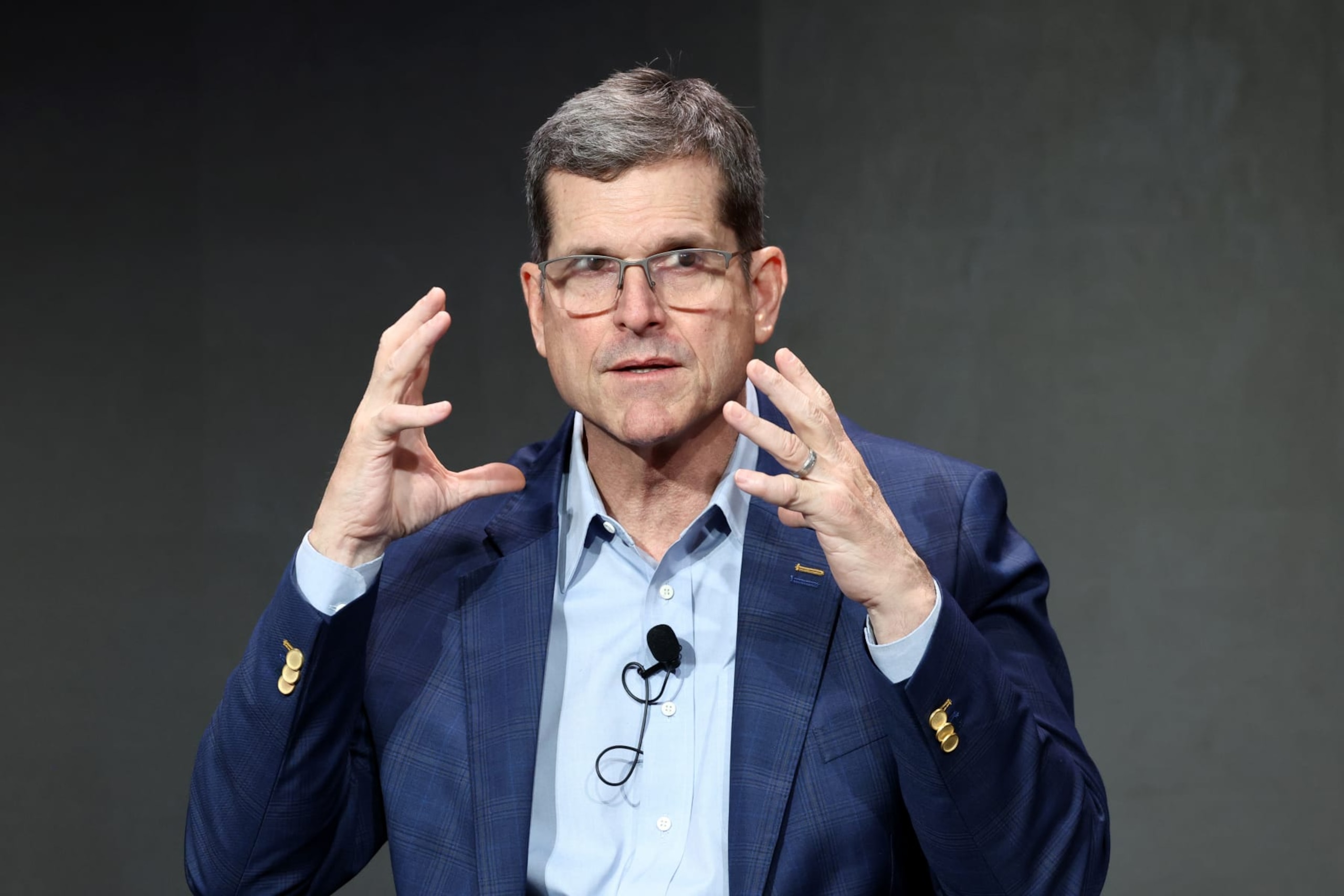LAS VEGAS, NEVADA - FEBRUARY 09: Jim Harbaugh speaks onstage during Verizon’s press conference at Verizon Live at Super Bowl LVIII on February 09, 2024 in Las Vegas, Nevada. (Photo by Mike Coppola/Getty Images for Verizon)