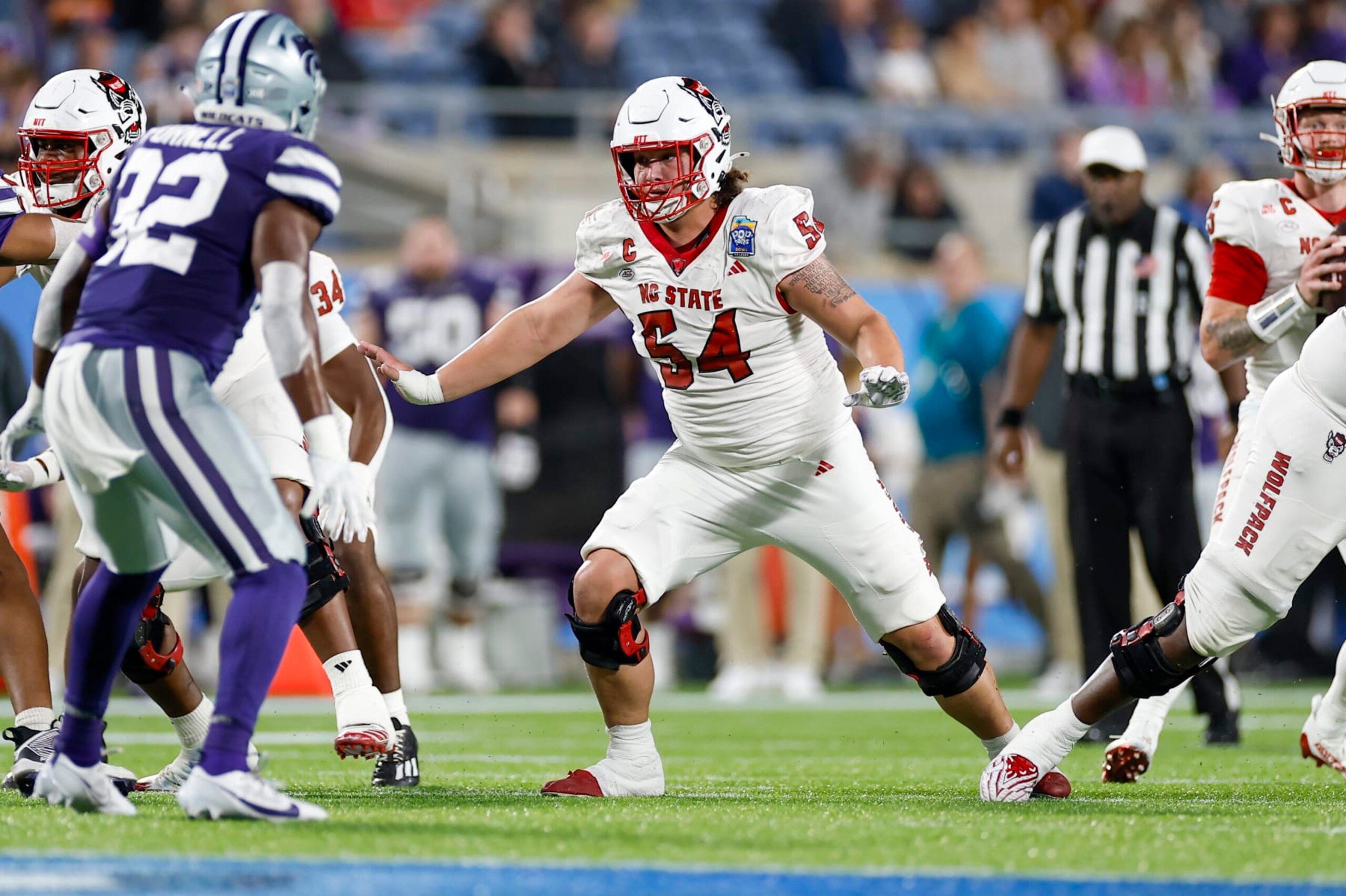 ORLANDO, FL - DECEMBER 28: North Carolina State Wolfpack offensive lineman Dylan McMahon (54) /blocls during the game between the North Carolina State Wolfpack and the Kansas State Wildcats on December 28, 2023 at Camping World Stadium in Orlando, Fl. (Photo by David Rosenblum/Icon Sportswire via Getty Images) ORLANDO, FL - DECEMBER 28: North Carolina State Wolfpack offensive lineman Dylan McMahon (54) /blocls during the game between the North Carolina State Wolfpack and the Kansas State Wildcats on December 28, 2023 at Camping World Stadium in Orlando, Fl. (Photo by David Rosenblum/Icon Sportswire via Getty Images)