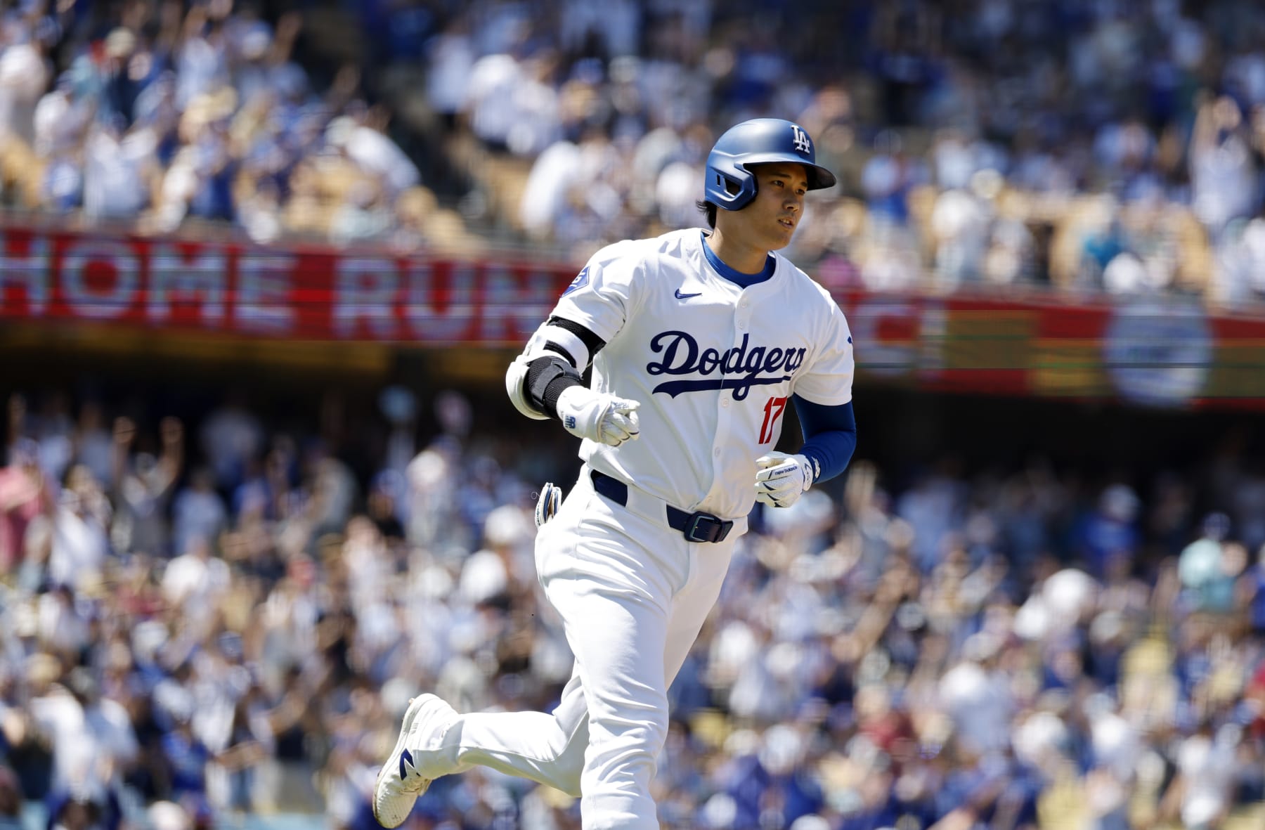 LOS ANGELES, CALIFORNIA - APRIL 21: Shohei Ohtani #17 of the Los Angeles Dodgers celebrate runs the bases  after hitting a two run home run against pitcher Adrian Houser #35 of the New York Mets  during the third inning at Dodger Stadium for his 176th career home run on April 21, 2024 in Los Angeles, California. Ohtani's 176th home run, broke a tie with Hideki Matsui for most by a Japanese born player. (Photo by Kevork Djansezian/Getty Images)