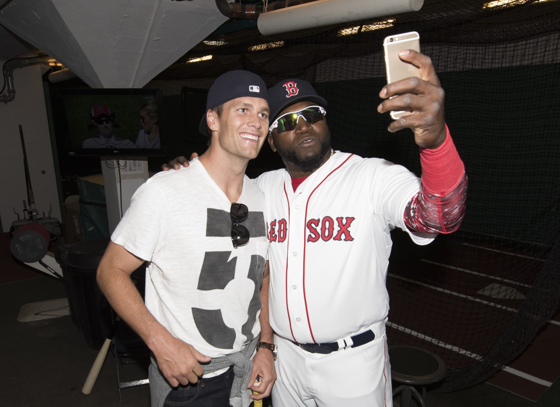 BOSTON, MA - APRIL 13: New England Patriots quarterback Tom Brady poses for a photograph with David Ortiz #34 of the Boston Red Sox in the batting cage after throwing out a ceremonial first pitch on Opening Day at Fenway Park on April 13, 2015 in Boston, Massachusetts. (Photo by Michael Ivins/Boston Red Sox/Getty Images)