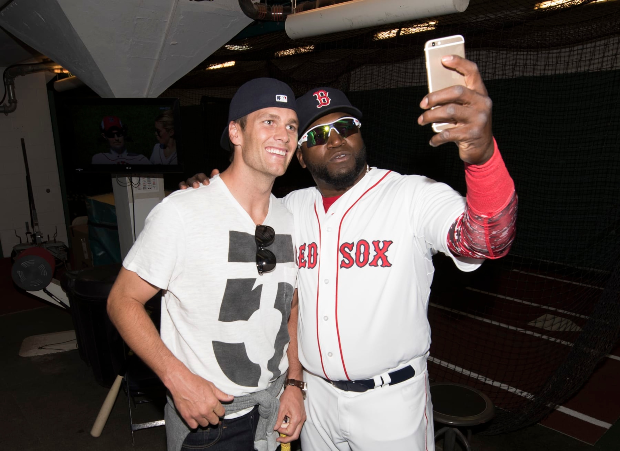 BOSTON, MA - APRIL 13: New England Patriots quarterback Tom Brady poses for a photograph with David Ortiz #34 of the Boston Red Sox in the batting cage after throwing out a ceremonial first pitch on Opening Day at Fenway Park on April 13, 2015 in Boston, Massachusetts. (Photo by Michael Ivins/Boston Red Sox/Getty Images)