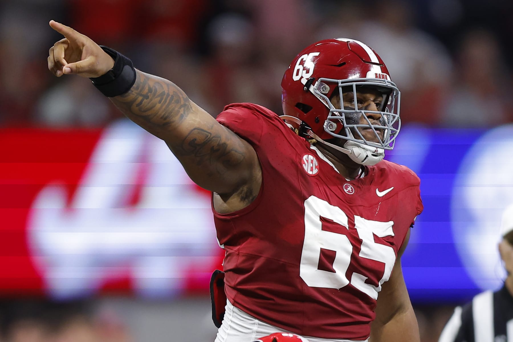ATLANTA, GEORGIA - DECEMBER 2: JC Latham #65 of the Alabama Crimson Tide reacts during the second quarter in the SEC Championship against the Georgia Bulldogs at Mercedes-Benz Stadium on December 2, 2023 in Atlanta, Georgia. (Photo by Todd Kirkland/Getty Images)