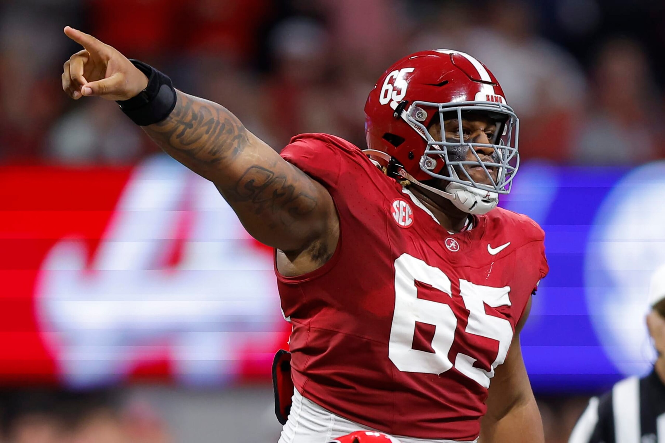ATLANTA, GEORGIA - DECEMBER 2: JC Latham #65 of the Alabama Crimson Tide reacts during the second quarter in the SEC Championship against the Georgia Bulldogs at Mercedes-Benz Stadium on December 2, 2023 in Atlanta, Georgia. (Photo by Todd Kirkland/Getty Images) ATLANTA, GEORGIA - DECEMBER 2: JC Latham #65 of the Alabama Crimson Tide reacts during the second quarter in the SEC Championship against the Georgia Bulldogs at Mercedes-Benz Stadium on December 2, 2023 in Atlanta, Georgia. (Photo by Todd Kirkland/Getty Images)