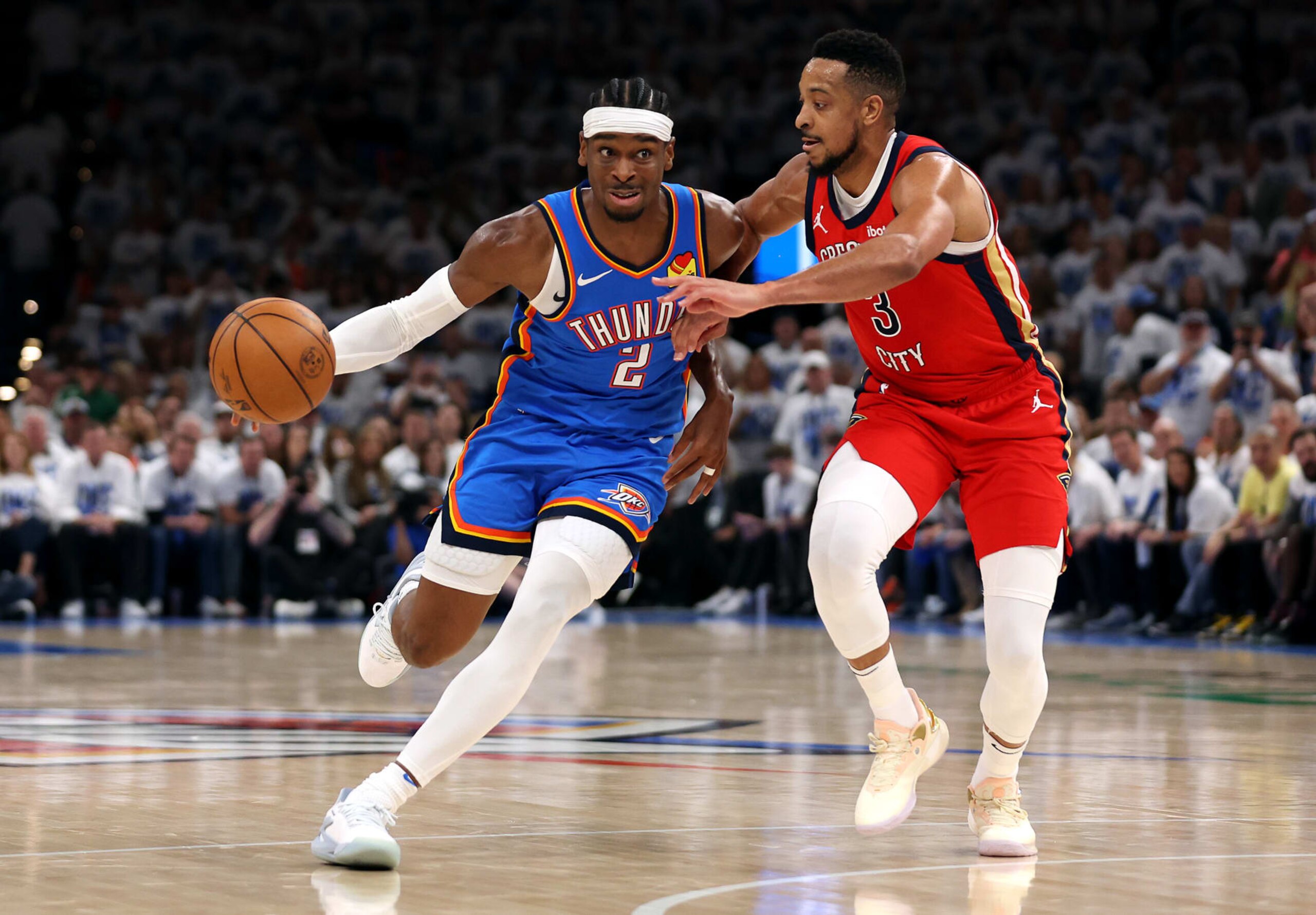 OKLAHOMA CITY, OKLAHOMA - APRIL 24: Shai Gilgeous-Alexander #2 of the Oklahoma City Thunder drives to the basket as CJ McCollum #3 of the New Orleans Pelicans defends during the first half of game two of the first round of the NBA playoffs at Paycom Center on April 24, 2024 in Oklahoma City, Oklahoma. (Photo by Jamie Squire/Getty Images) OKLAHOMA CITY, OKLAHOMA - APRIL 24: Shai Gilgeous-Alexander #2 of the Oklahoma City Thunder drives to the basket as CJ McCollum #3 of the New Orleans Pelicans defends during the first half of game two of the first round of the NBA playoffs at Paycom Center on April 24, 2024 in Oklahoma City, Oklahoma. (Photo by Jamie Squire/Getty Images)