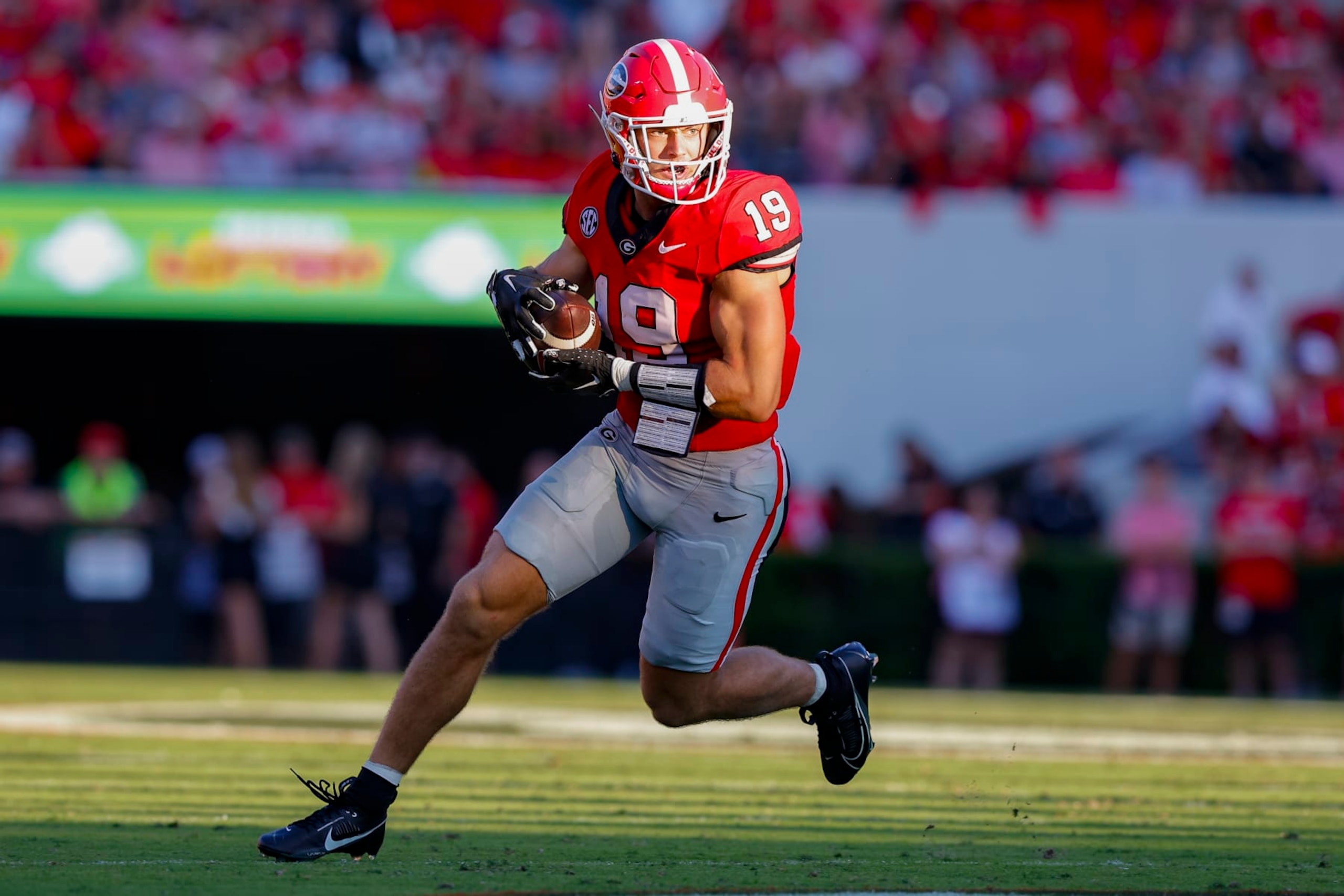 ATHENS, GEORGIA - SEPTEMBER 2: Brock Bowers #19 of the Georgia Bulldogs looks for extra yardage after the reception during the second quarter against the Tennessee Martin Skyhawks at Sanford Stadium on September 2, 2023 in Athens, Georgia. (Photo by Todd Kirkland/Getty Images)