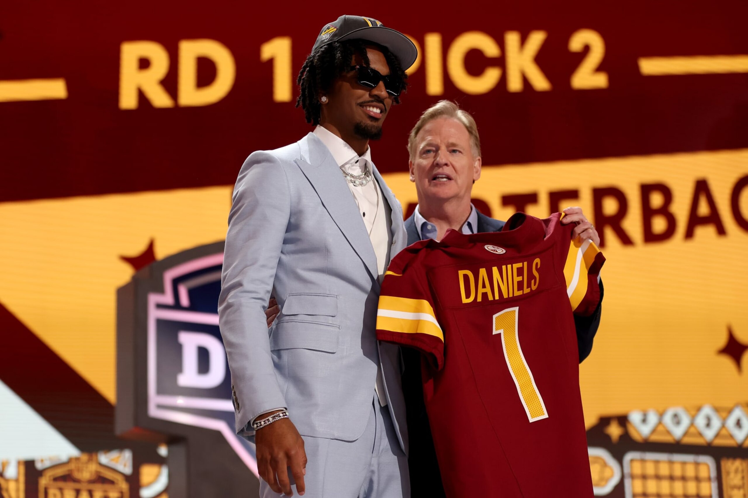 DETROIT, MICHIGAN - APRIL 25: Jayden Daniels poses with NFL Commissioner Roger Goodell after being selected second overall by the Washington Commanders during the first round of the 2024 NFL Draft at Campus Martius Park and Hart Plaza on April 25, 2024 in Detroit, Michigan. (Photo by Gregory Shamus/Getty Images) DETROIT, MICHIGAN - APRIL 25: Jayden Daniels poses with NFL Commissioner Roger Goodell after being selected second overall by the Washington Commanders during the first round of the 2024 NFL Draft at Campus Martius Park and Hart Plaza on April 25, 2024 in Detroit, Michigan. (Photo by Gregory Shamus/Getty Images)