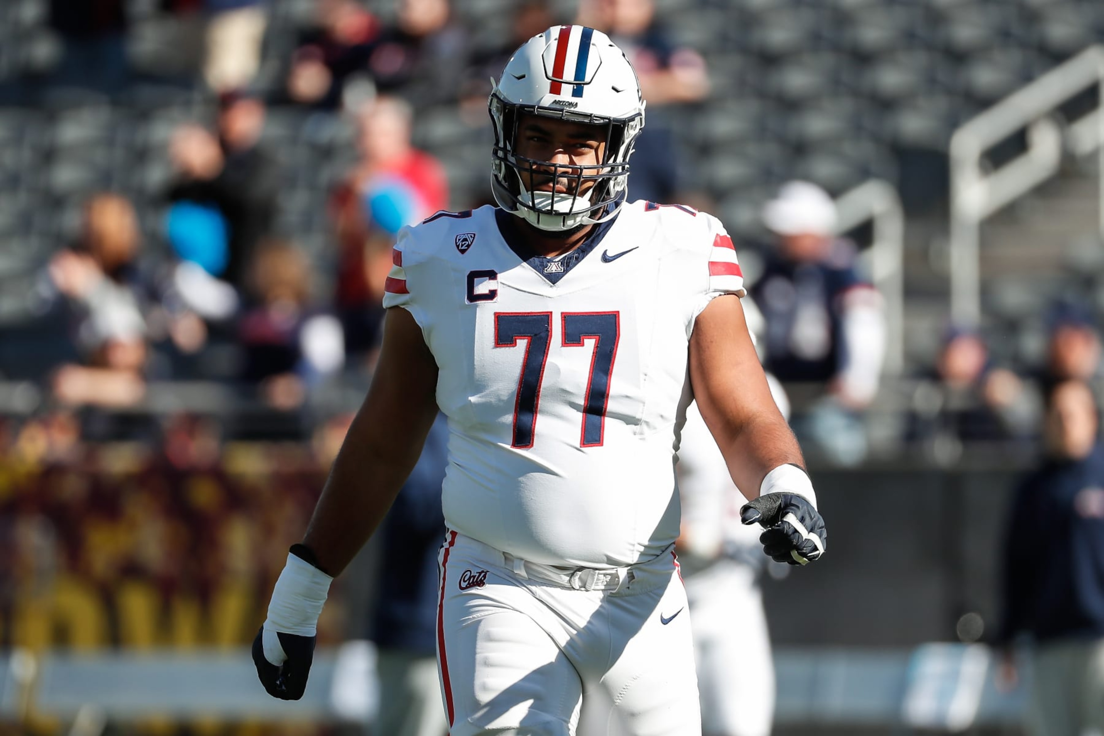 TEMPE, AZ - NOVEMBER 25: Arizona Wildcats offensive lineman Jordan Morgan (77) looks on before the college football game between the Arizona Wildcats and the Arizona State Sun Devils on November 25, 2023 at Mountain America Stadium in Tempe, Arizona. (Photo by Kevin Abele/Icon Sportswire via Getty Images) TEMPE, AZ - NOVEMBER 25: Arizona Wildcats offensive lineman Jordan Morgan (77) looks on before the college football game between the Arizona Wildcats and the Arizona State Sun Devils on November 25, 2023 at Mountain America Stadium in Tempe, Arizona. (Photo by Kevin Abele/Icon Sportswire via Getty Images)