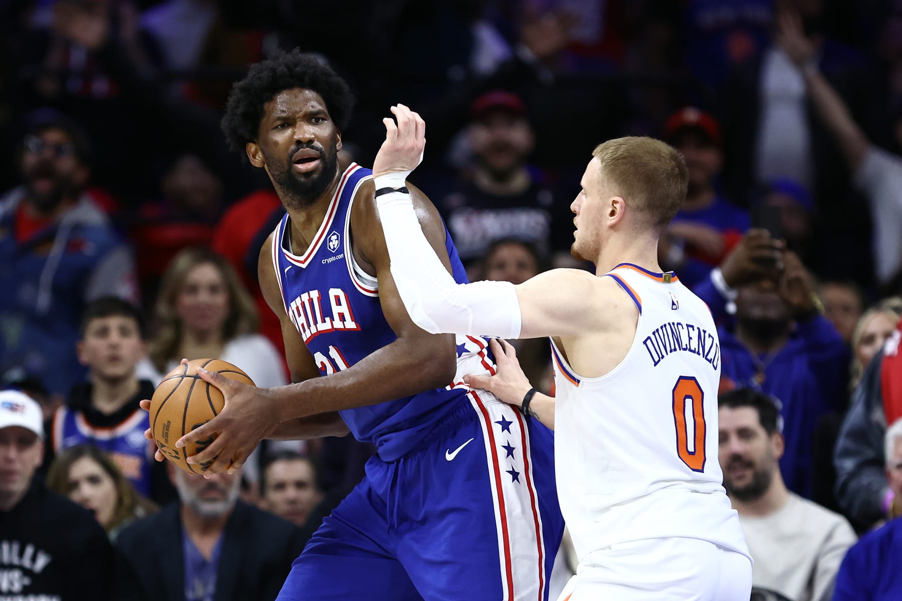 PHILADELPHIA, PENNSYLVANIA - APRIL 25: Joel Embiid #21 of the Philadelphia 76ers is guarded by Donte DiVincenzo #0 of the New York Knicks during the fourth quarter of game three of the Eastern Conference First Round Playoffs at the Wells Fargo Center on April 25, 2024 in Philadelphia, Pennsylvania. NOTE TO USER: User expressly acknowledges and agrees that, by downloading and/or using this Photograph, user is consenting to the terms and conditions of the Getty Images License Agreement. (Photo by Tim Nwachukwu/Getty Images) PHILADELPHIA, PENNSYLVANIA - APRIL 25: Joel Embiid #21 of the Philadelphia 76ers is guarded by Donte DiVincenzo #0 of the New York Knicks during the fourth quarter of game three of the Eastern Conference First Round Playoffs at the Wells Fargo Center on April 25, 2024 in Philadelphia, Pennsylvania. NOTE TO USER: User expressly acknowledges and agrees that, by downloading and/or using this Photograph, user is consenting to the terms and conditions of the Getty Images License Agreement. (Photo by Tim Nwachukwu/Getty Images)