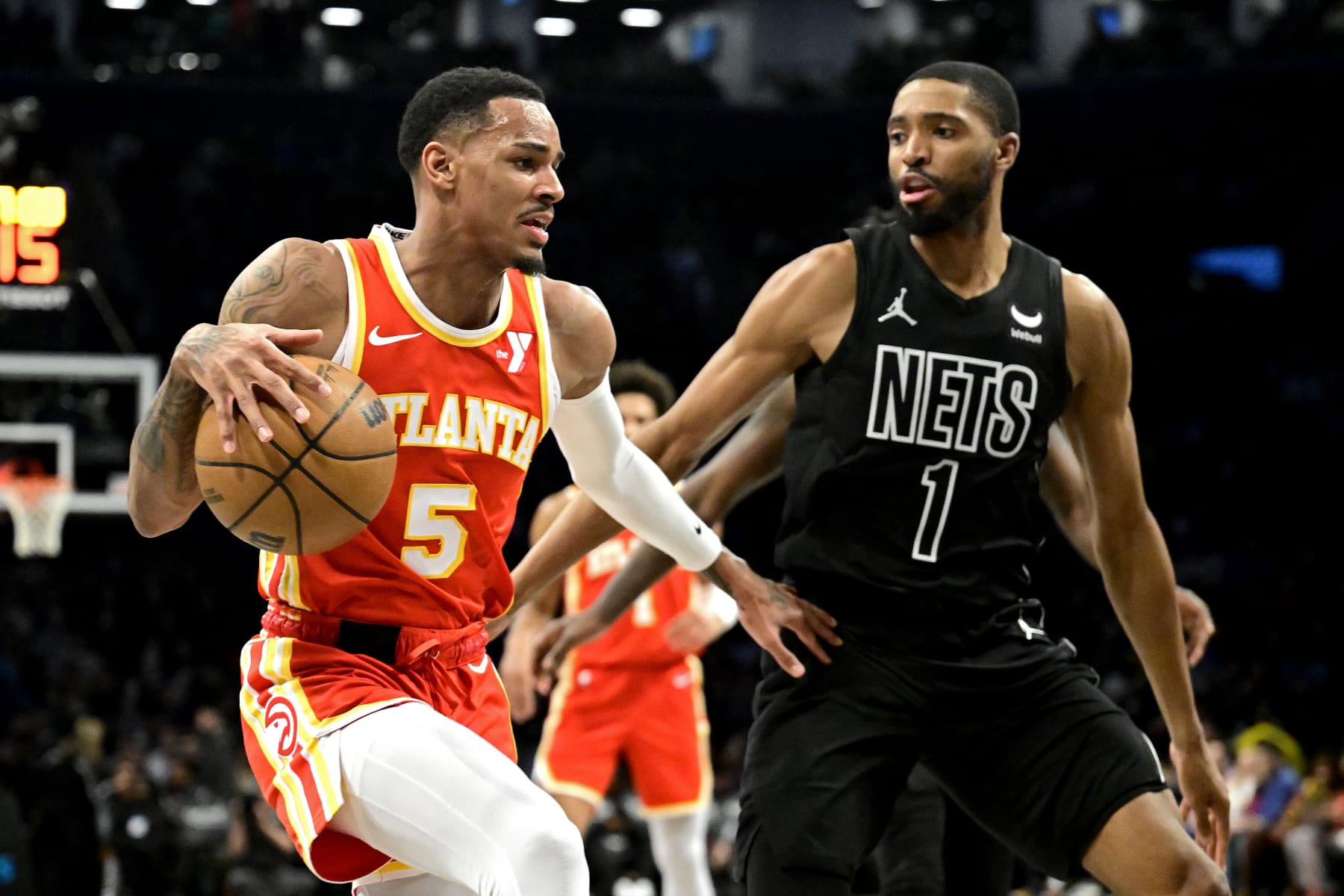NEW YORK, NEW YORK - FEBRUARY 29:  Dejounte Murray #5 of the Atlanta Hawks is defended by Mikal Bridges #1 of the Brooklyn Nets during the game at Barclays Center on February 29, 2024 in New York City. NOTE TO USER: User expressly acknowledges and agrees that, by downloading and or using this photograph, User is consenting to the terms and conditions of the Getty Images License Agreement. (Photo by Steven Ryan/Getty Images)