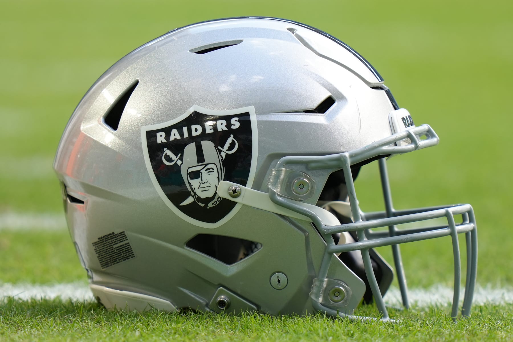 MIAMI GARDENS, FL - NOVEMBER 19: a Las Vegas Raiders helmet rests on the field before the game between the Las Vegas Raiders and the Miami Dolphins on Sunday, November 19, 2023 at Hard Rock Stadium, Miami, Fla. (Photo by Peter Joneleit/Icon Sportswire via Getty Images)