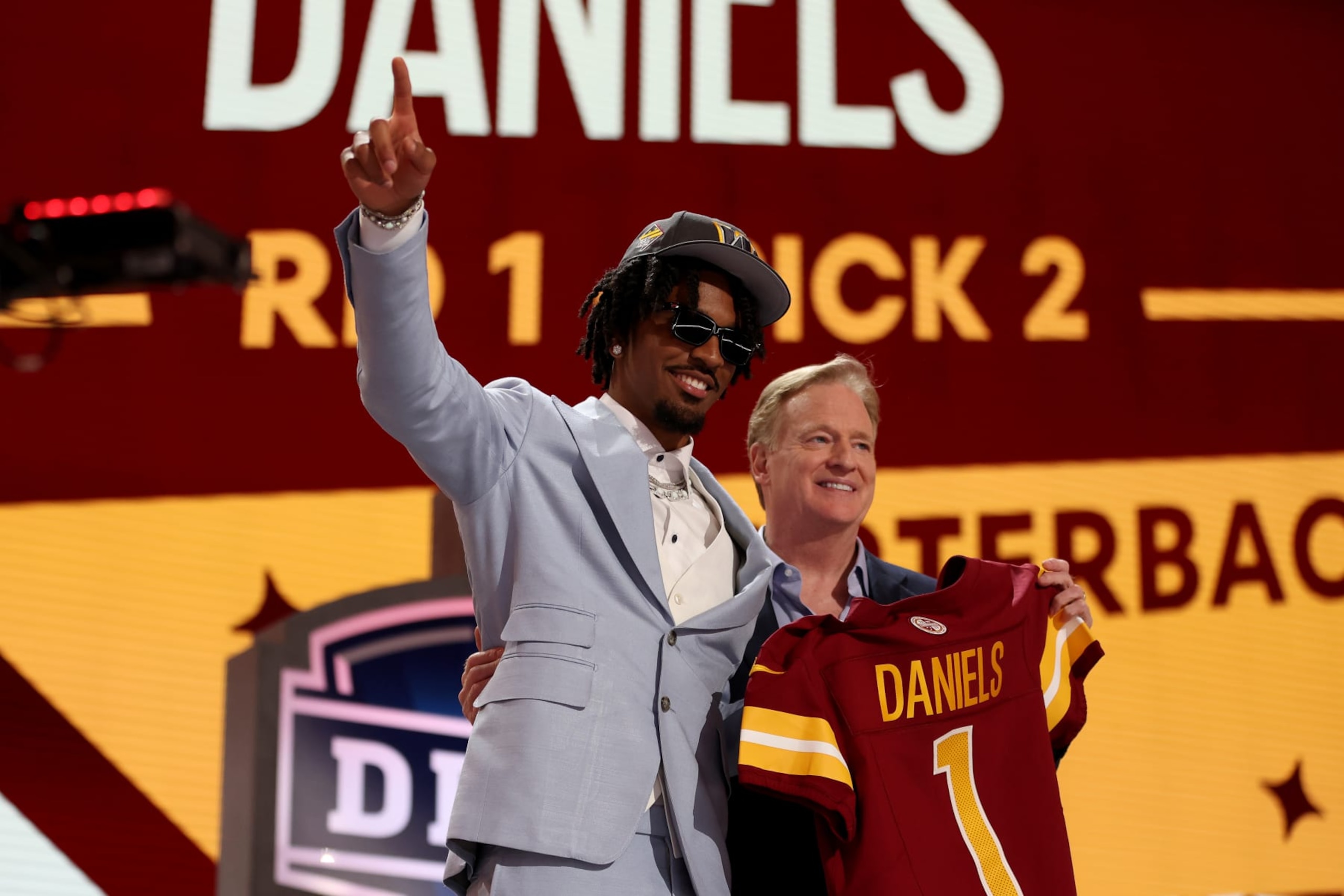 DETROIT, MICHIGAN - APRIL 25: Jayden Daniels poses with NFL Commissioner Roger Goodell after being selected second overall by the Washington Commanders during the first round of the 2024 NFL Draft at Campus Martius Park and Hart Plaza on April 25, 2024 in Detroit, Michigan. (Photo by Gregory Shamus/Getty Images)