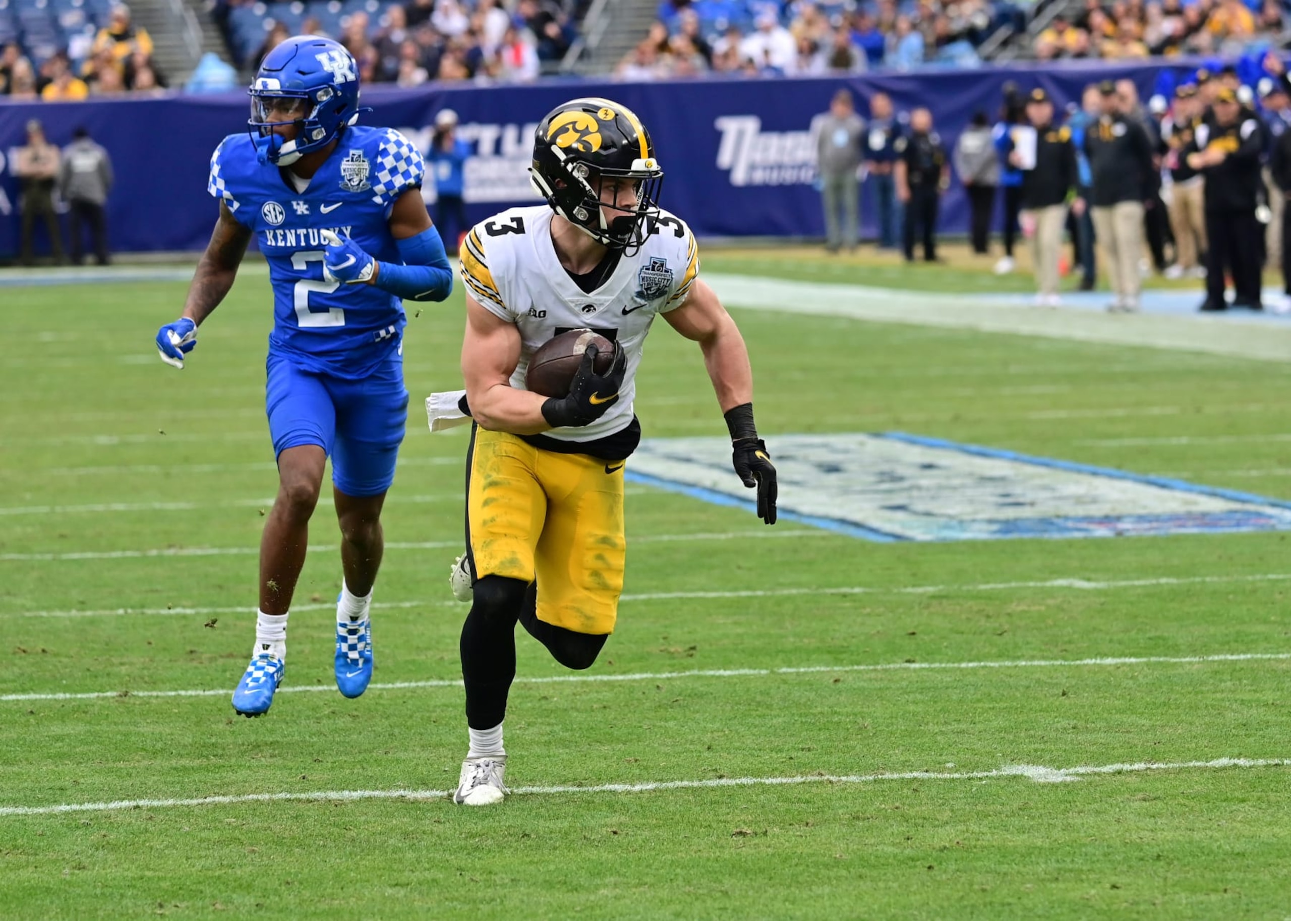 NASHVILLE, TN - DECEMBER 31: Iowa left cornerback Cooper DeJean (3) returns a pass interception 14 yards for a touchdown during the TransPerfect Music City Bowl game between the Kentucky Wildcats and the Iowa Hawkeyes on December 31, 2022, at Nissan Stadium in Nashville, TN (Photo by Keith Gillett/Icon Sportswire via Getty Images)