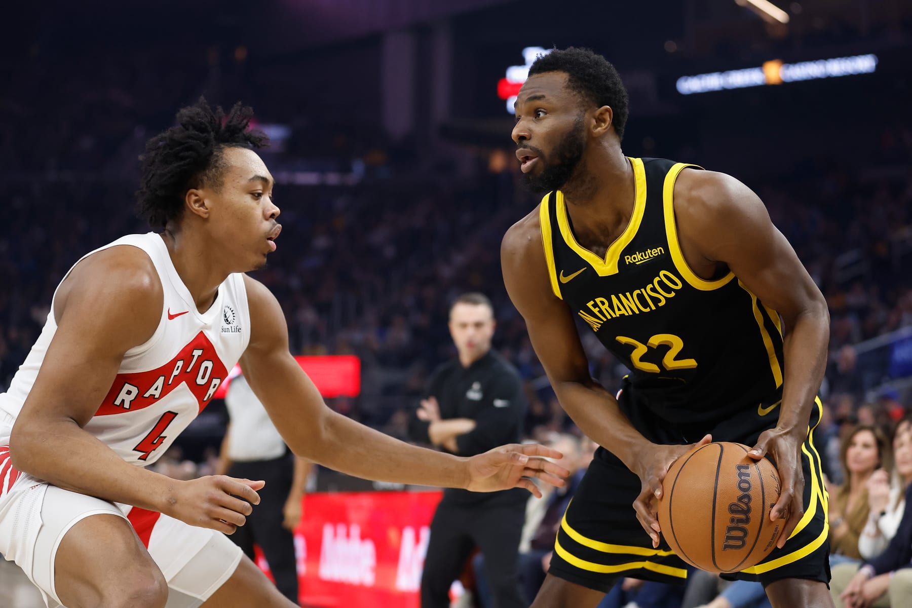 SAN FRANCISCO, CALIFORNIA - JANUARY 07: Andrew Wiggins #22 of the Golden State Warriors is guarded by Scottie Barnes #4 of the Toronto Raptors in the first quarter at Chase Center on January 07, 2024 in San Francisco, California. NOTE TO USER: User expressly acknowledges and agrees that, by downloading and or using this photograph, User is consenting to the terms and conditions of the Getty Images License Agreement. (Photo by Lachlan Cunningham/Getty Images)