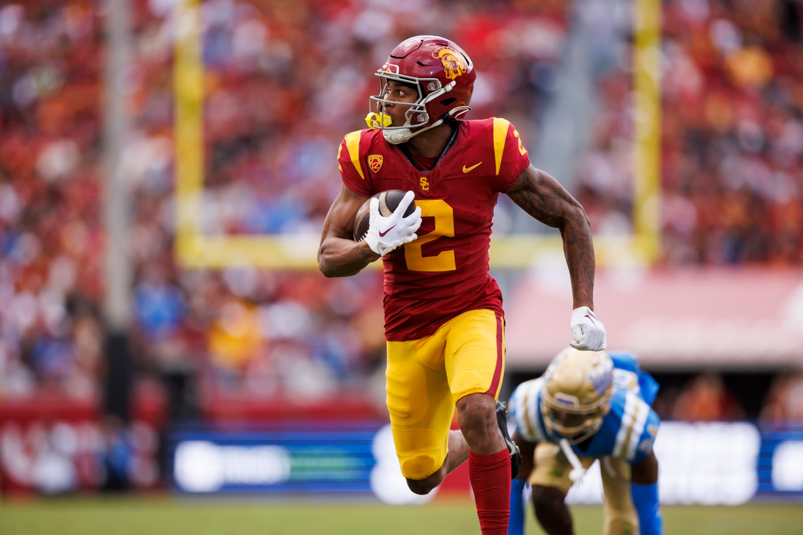 LOS ANGELES, CALIFORNIA - NOVEMBER 18: Brenden Rice #2 of the USC Trojans runs the ball after a catch to score a touchdown during the first half of a game against the UCLA Bruins at United Airlines Field at the Los Angeles Memorial Coliseum on November 18, 2023 in Los Angeles, California. (Photo by Ryan Kang/Getty Images)
