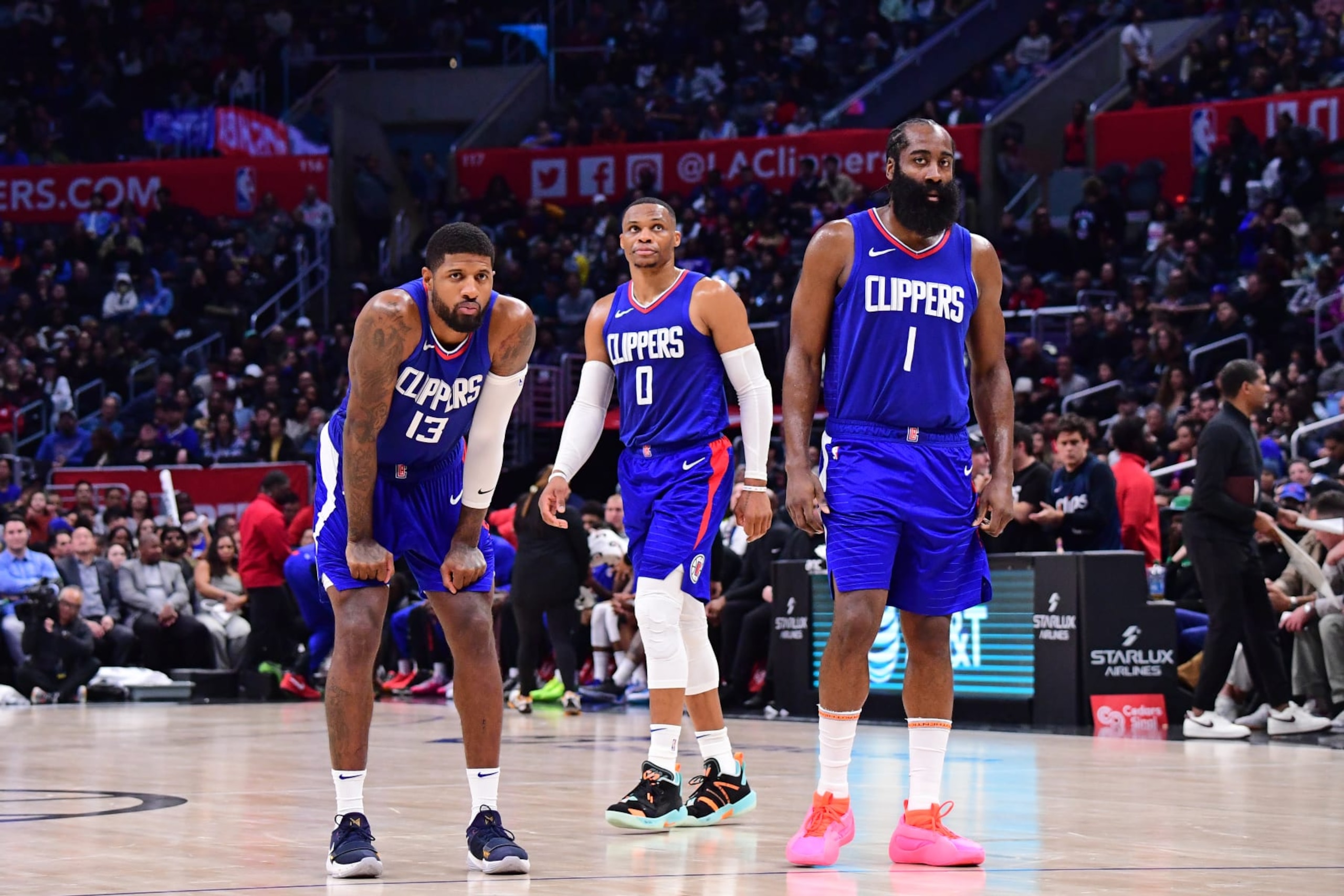 LOS ANGELES, CA - NOVEMBER 27: Russell Westbrook #0, Paul George #13, and James Harden #1 of the LA Clippers look on during the game against the Denver Nuggets on November 27, 2023 at Crypto.Com Arena in Los Angeles, California. NOTE TO USER: User expressly acknowledges and agrees that, by downloading and/or using this Photograph, user is consenting to the terms and conditions of the Getty Images License Agreement. Mandatory Copyright Notice: Copyright 2023 NBAE (Photo by Adam Pantozzi/NBAE via Getty Images)