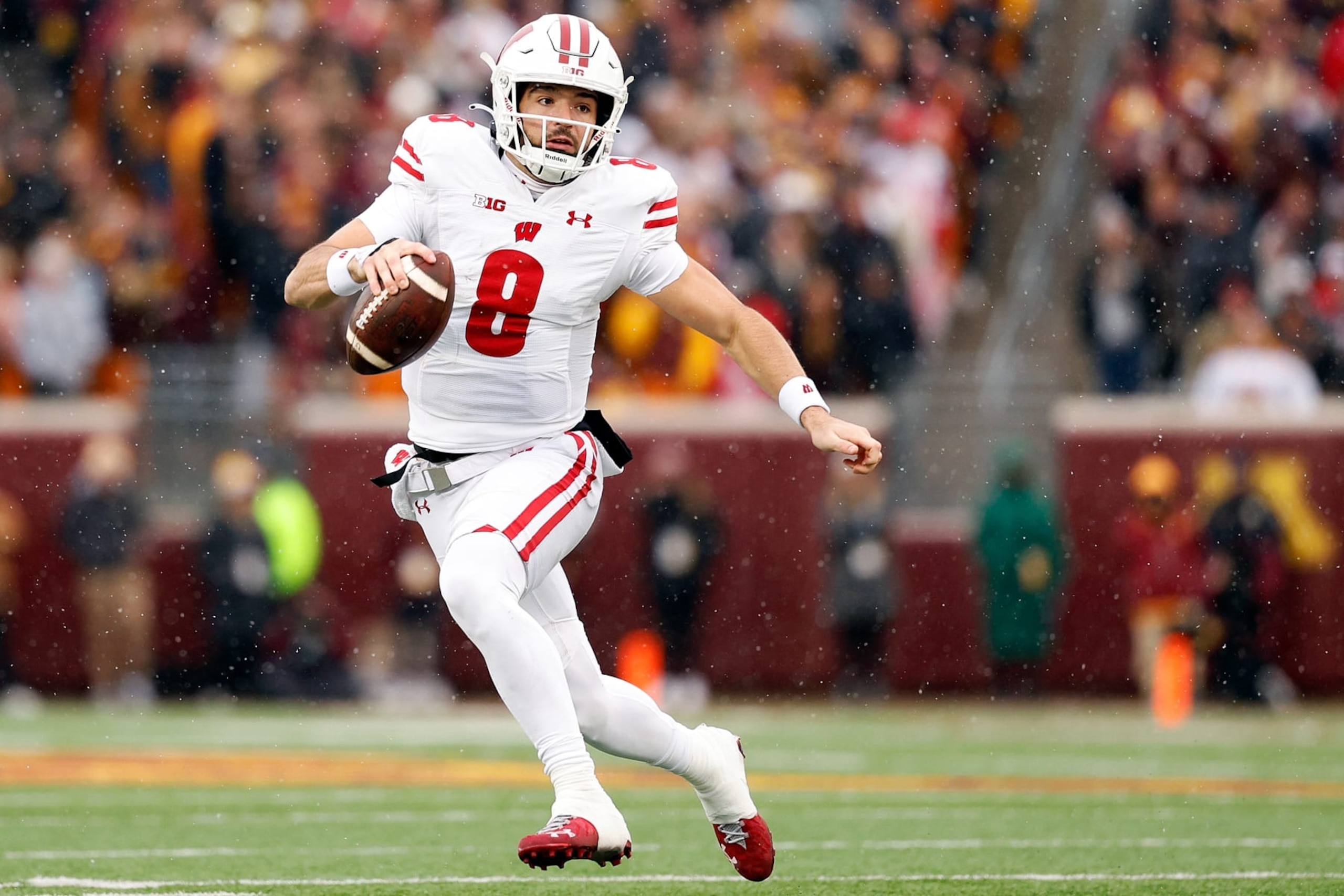 MINNEAPOLIS, MINNESOTA - NOVEMBER 25: Tanner Mordecai #8 of the Wisconsin Badgers runs with the ball against the Minnesota Golden Gophers in the first half at Huntington Bank Stadium on November 25, 2023 in Minneapolis, Minnesota. (Photo by David Berding/Getty Images)