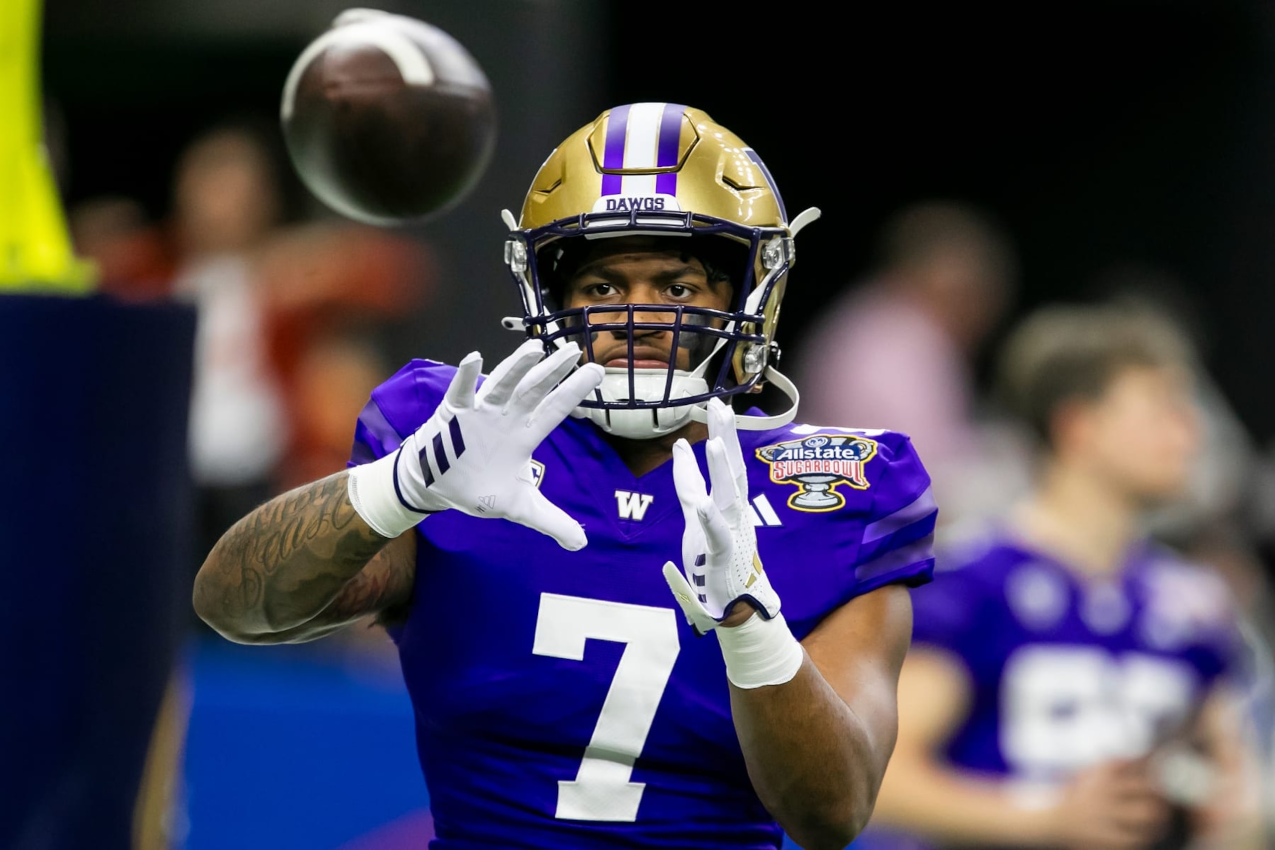 NEW ORLEANS, LA - JANUARY 01: Washington running back Dillon Johnson (7) catches a pass in warmups prior to the All State Sugar Bowl playoff game between the Texas Longhorns and the Washington Huskies on Monday, January 1, 2024 at Caesars Superdome in New Orleans, LA.  (Photo by Nick Tre. Smith/Icon Sportswire via Getty Images)