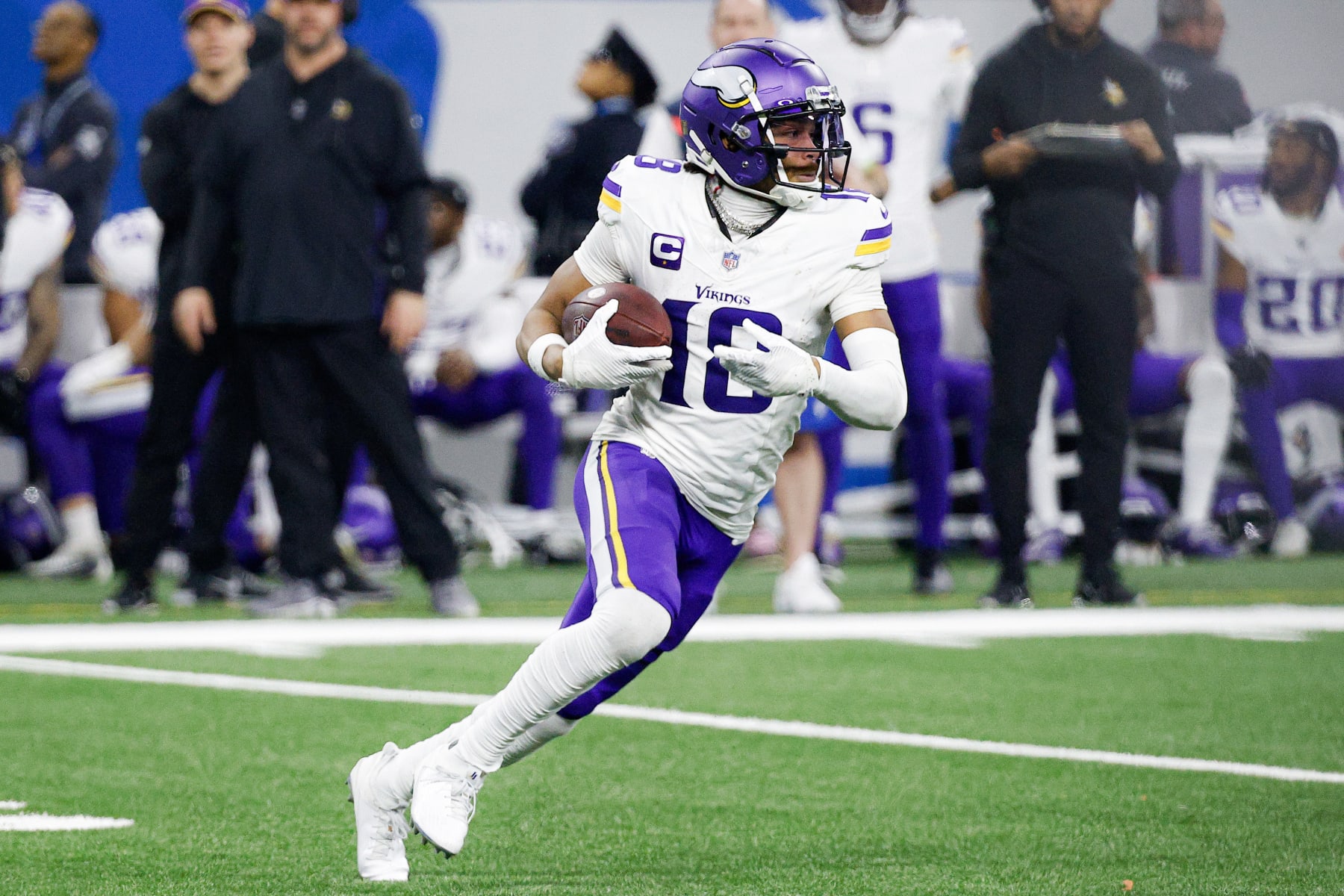 DETROIT, MICHIGAN - JANUARY 07: Justin Jefferson #18 of the Minnesota Vikings runs the ball up the field after a catch during the second half of a game against the Detroit Lions at Ford Field on January 07, 2024 in Detroit, Michigan. (Photo by Mike Mulholland/Getty Images)