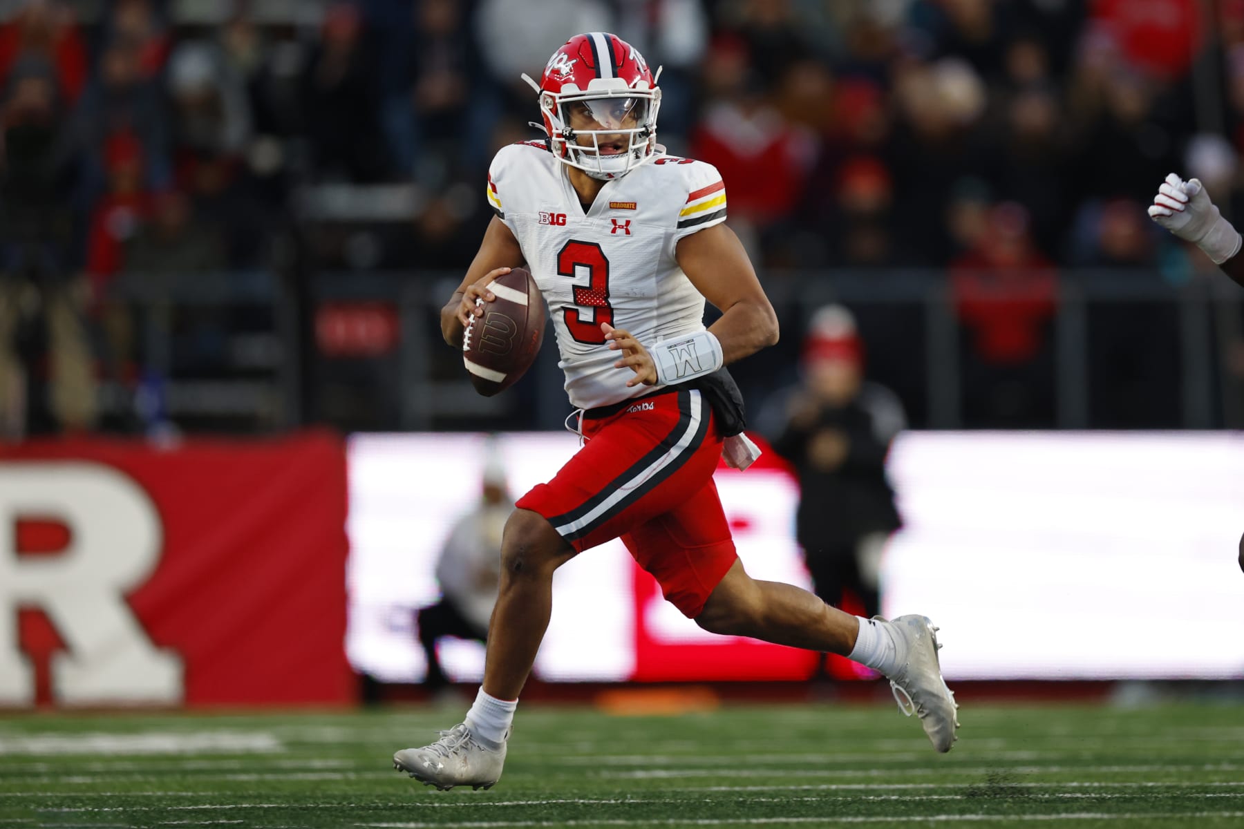 PISCATAWAY, NEW JERSEY - NOVEMBER 25:  Quarterback Taulia Tagovailoa #3 of the Maryland Terrapins attempts a pass on the run against the Rutgers Scarlet Knights during the first quarter of a game at SHI Stadium on November 25, 2023 in Piscataway, New Jersey. (Photo by Rich Schultz/Getty Images)