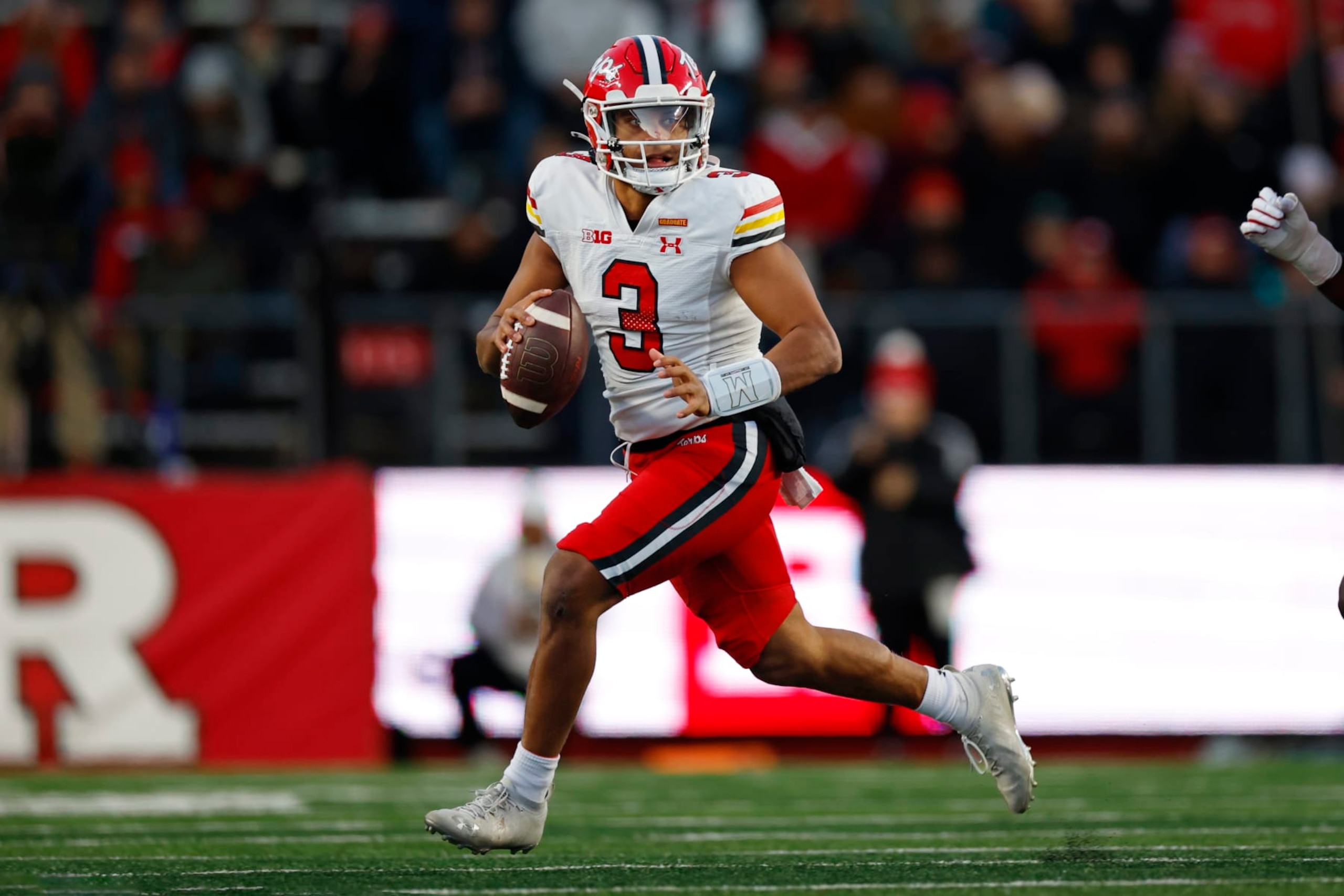PISCATAWAY, NEW JERSEY - NOVEMBER 25:  Quarterback Taulia Tagovailoa #3 of the Maryland Terrapins attempts a pass on the run against the Rutgers Scarlet Knights during the first quarter of a game at SHI Stadium on November 25, 2023 in Piscataway, New Jersey. (Photo by Rich Schultz/Getty Images)