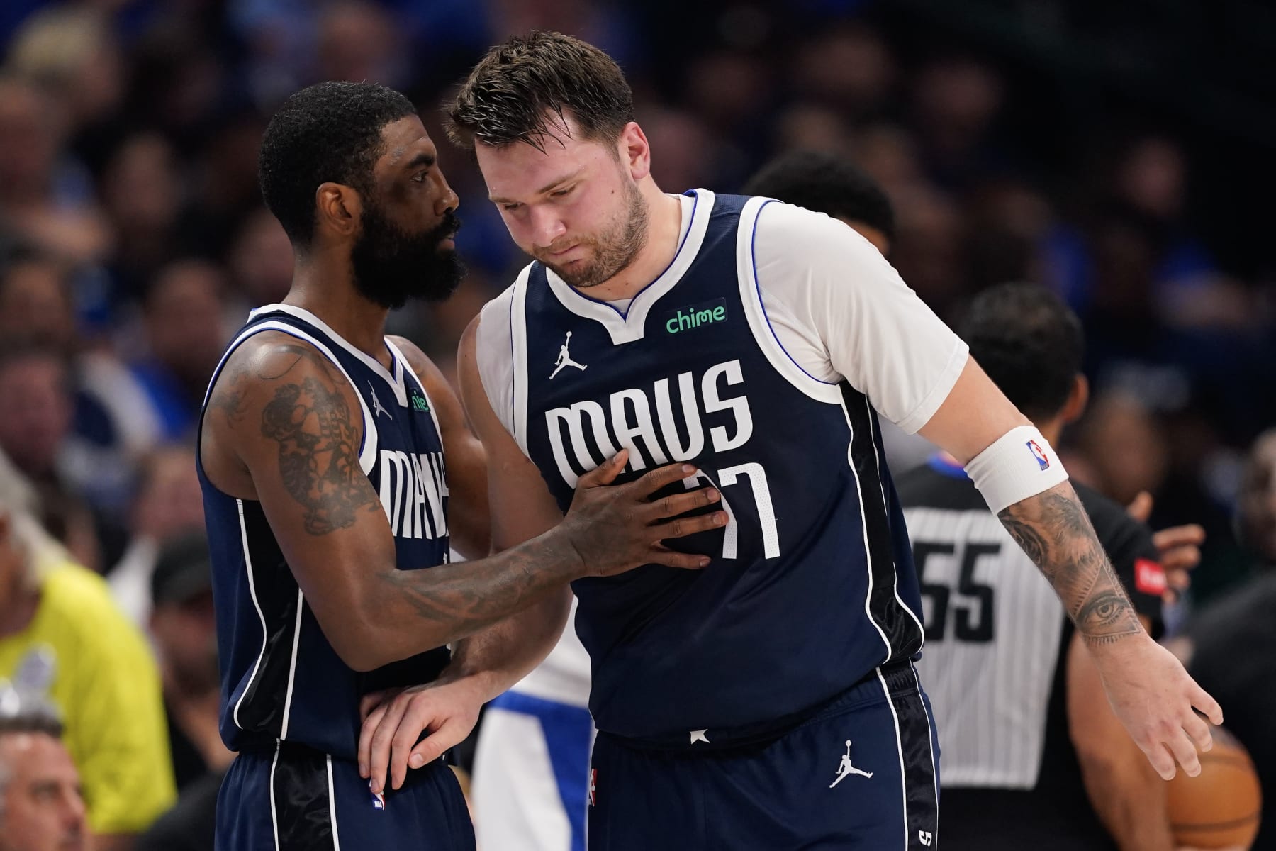 DALLAS, TEXAS - APRIL 26: Luka Doncic #77 of the Dallas Mavericks is greeted by Kyrie Irving #11 as he walks off the court after being injured during the first half of game three of the Western Conference First Round Playoffs at American Airlines Center on April 26, 2024 in Dallas, Texas. NOTE TO USER: User expressly acknowledges and agrees that, by downloading and or using this photograph, User is consenting to the terms and conditions of the Getty Images License Agreement. (Photo by Sam Hodde/Getty Images)