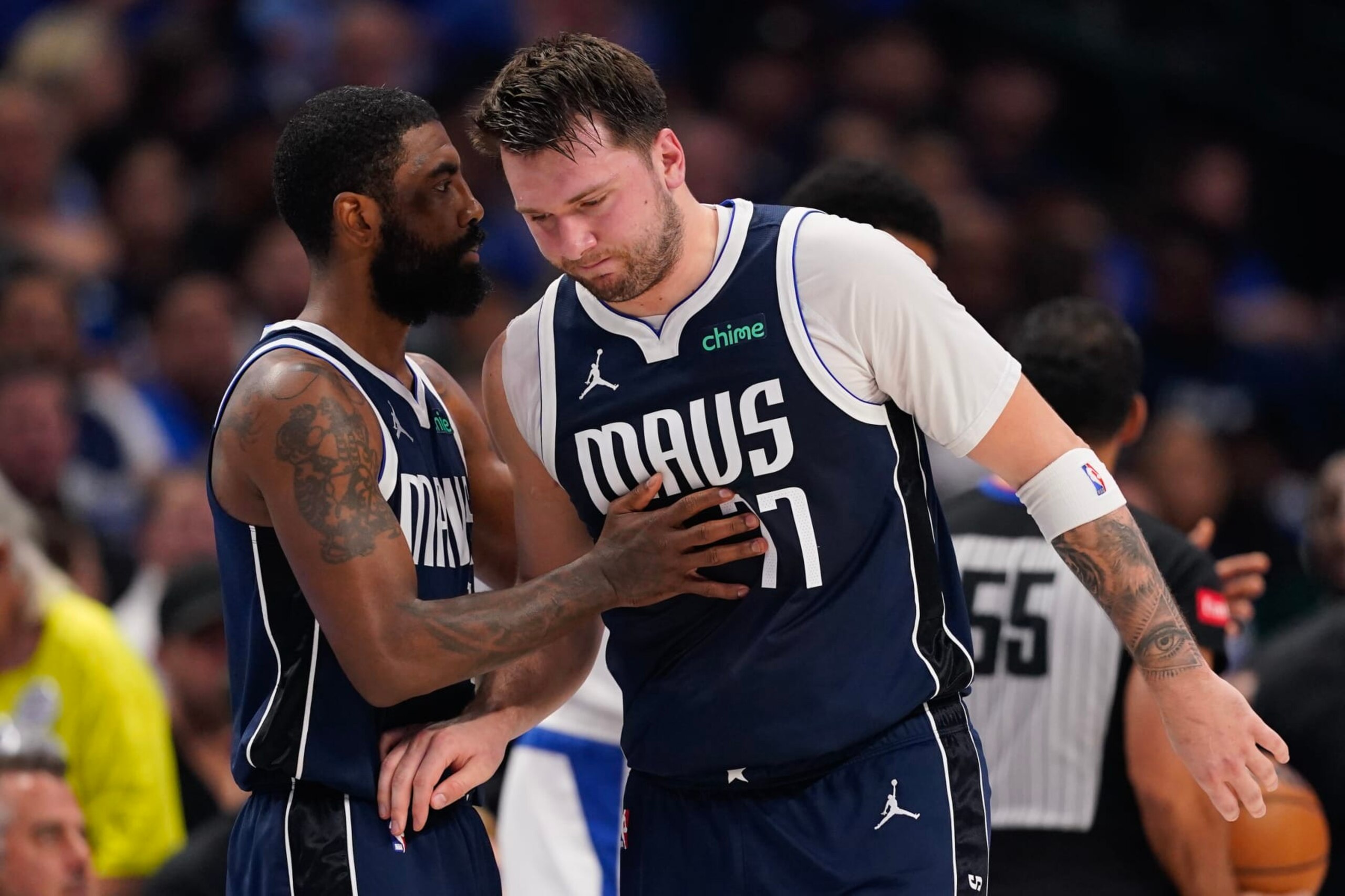 DALLAS, TEXAS - APRIL 26: Luka Doncic #77 of the Dallas Mavericks is greeted by Kyrie Irving #11 as he walks off the court after being injured during the first half of game three of the Western Conference First Round Playoffs at American Airlines Center on April 26, 2024 in Dallas, Texas. NOTE TO USER: User expressly acknowledges and agrees that, by downloading and or using this photograph, User is consenting to the terms and conditions of the Getty Images License Agreement. (Photo by Sam Hodde/Getty Images) DALLAS, TEXAS - APRIL 26: Luka Doncic #77 of the Dallas Mavericks is greeted by Kyrie Irving #11 as he walks off the court after being injured during the first half of game three of the Western Conference First Round Playoffs at American Airlines Center on April 26, 2024 in Dallas, Texas. NOTE TO USER: User expressly acknowledges and agrees that, by downloading and or using this photograph, User is consenting to the terms and conditions of the Getty Images License Agreement. (Photo by Sam Hodde/Getty Images)