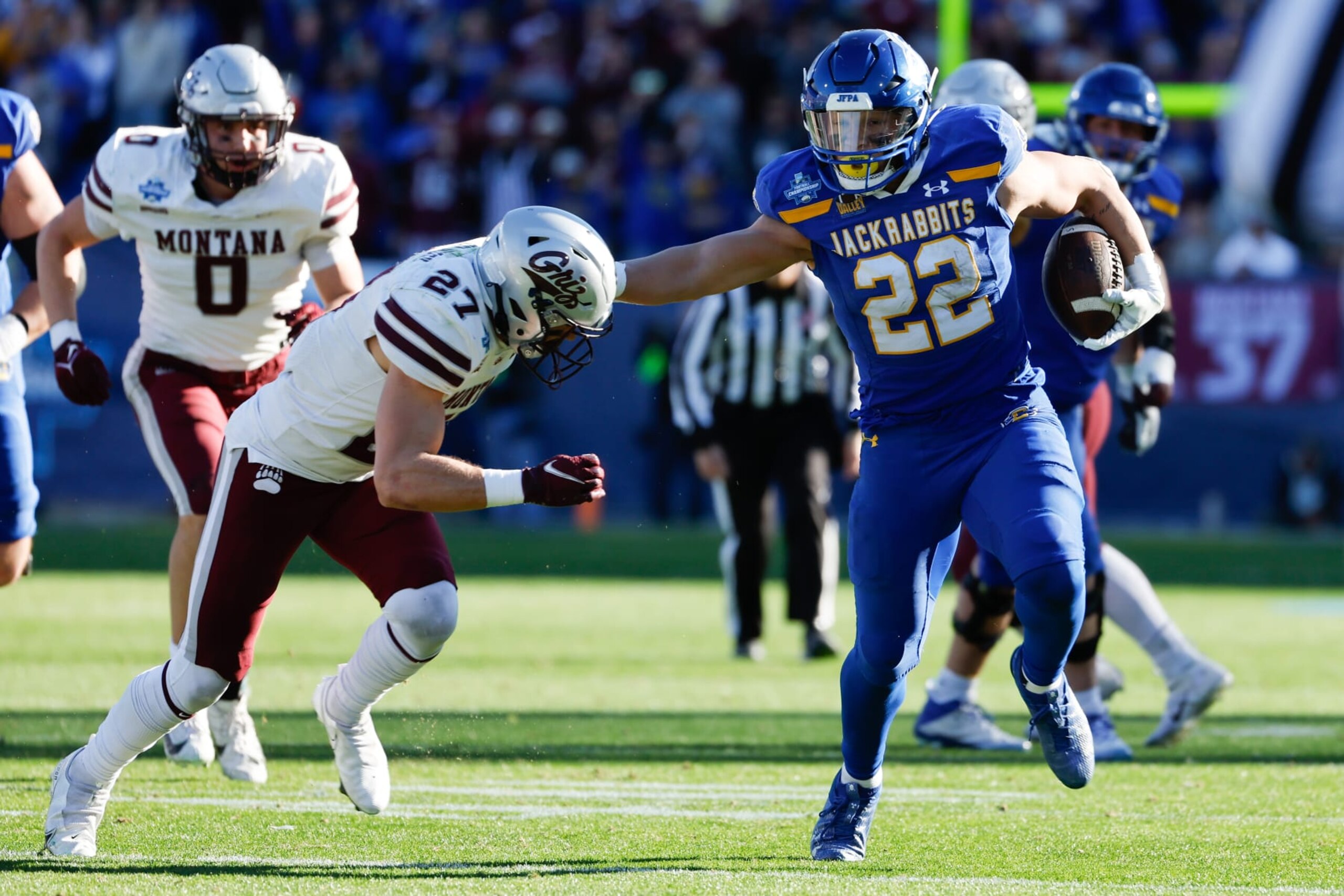 FRISCO, TEXAS - JANUARY 07: Isaiah Davis #22 of the South Dakota State Jackrabbits stiff arms Trevin Gradney #27 of the Montana Grizzlies during the Division I FCS Football Championship held at Toyota Stadium on January 7, 2024 in Frisco, Texas. (Photo by C. Morgan Engel/NCAA Photos via Getty Images) FRISCO, TEXAS - JANUARY 07: Isaiah Davis #22 of the South Dakota State Jackrabbits stiff arms Trevin Gradney #27 of the Montana Grizzlies during the Division I FCS Football Championship held at Toyota Stadium on January 7, 2024 in Frisco, Texas. (Photo by C. Morgan Engel/NCAA Photos via Getty Images)