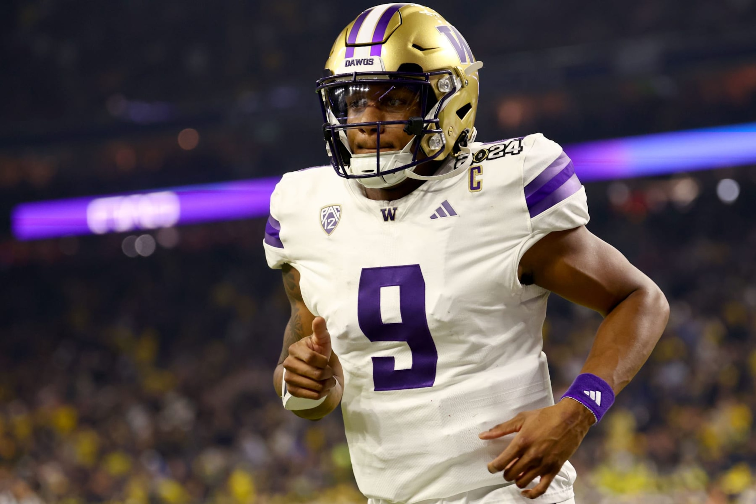 HOUSTON, TEXAS - JANUARY 8: Michael Penix Jr. #9 of the Washington Huskies heads to the locker room at halftime against the Michigan Wolverines during the 2024 CFP National Championship game at NRG Stadium on January 8, 2024 in Houston, Texas. (Photo by Jamie Schwaberow/Getty Images) HOUSTON, TEXAS - JANUARY 8: Michael Penix Jr. #9 of the Washington Huskies heads to the locker room at halftime against the Michigan Wolverines during the 2024 CFP National Championship game at NRG Stadium on January 8, 2024 in Houston, Texas. (Photo by Jamie Schwaberow/Getty Images)