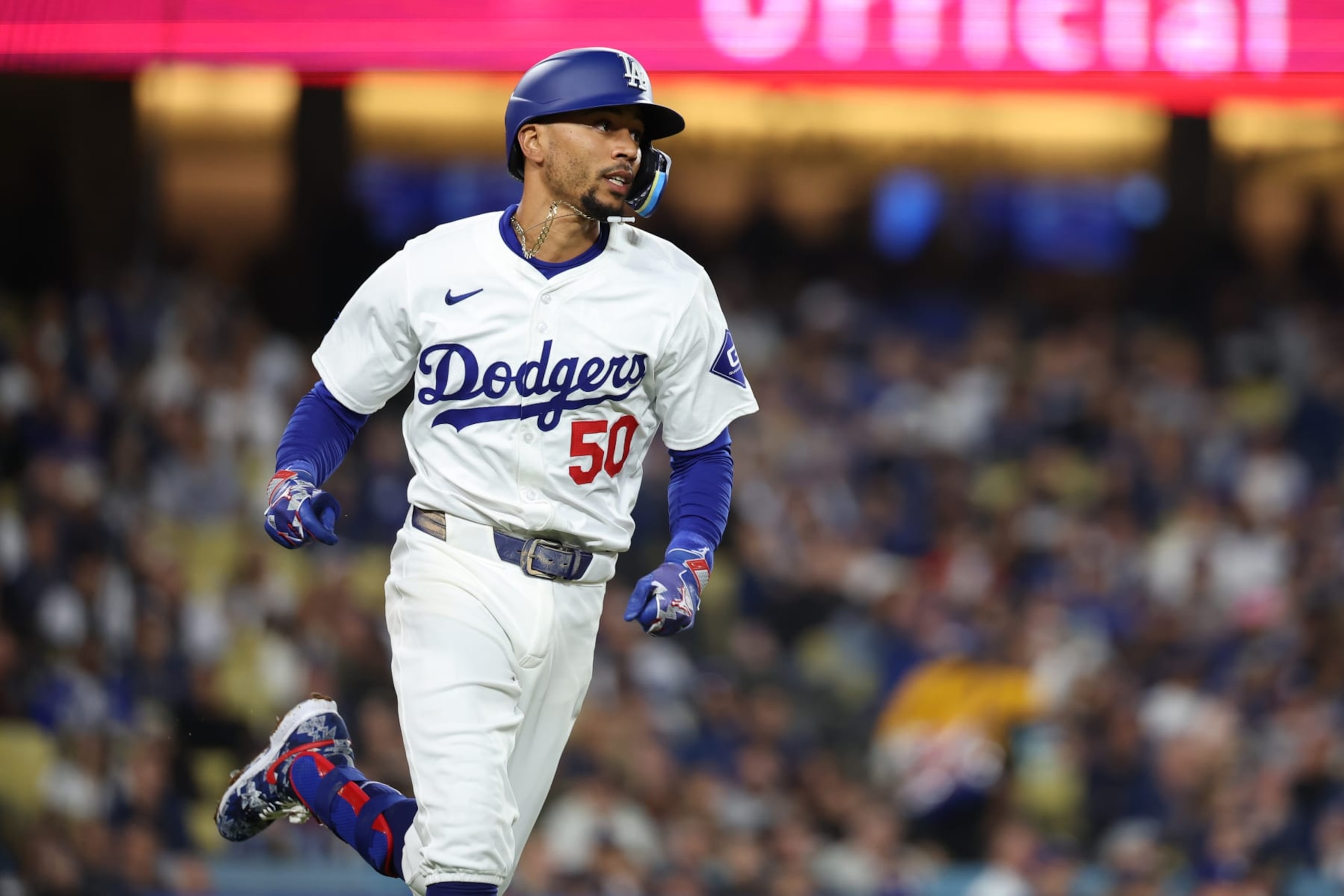 LOS ANGELES, CA - APRIL 03: Los Angeles Dodgers shortstop Mookie Betts (50) runs to first base after making contact at the plate during the game between the San Francisco Giants and the Los Angeles Dodgers on Wednesday, April 3, 2024 at Dodger Stadium, Los Angeles, CA. (Photo by Peter Joneleit/Icon Sportswire via Getty Images)