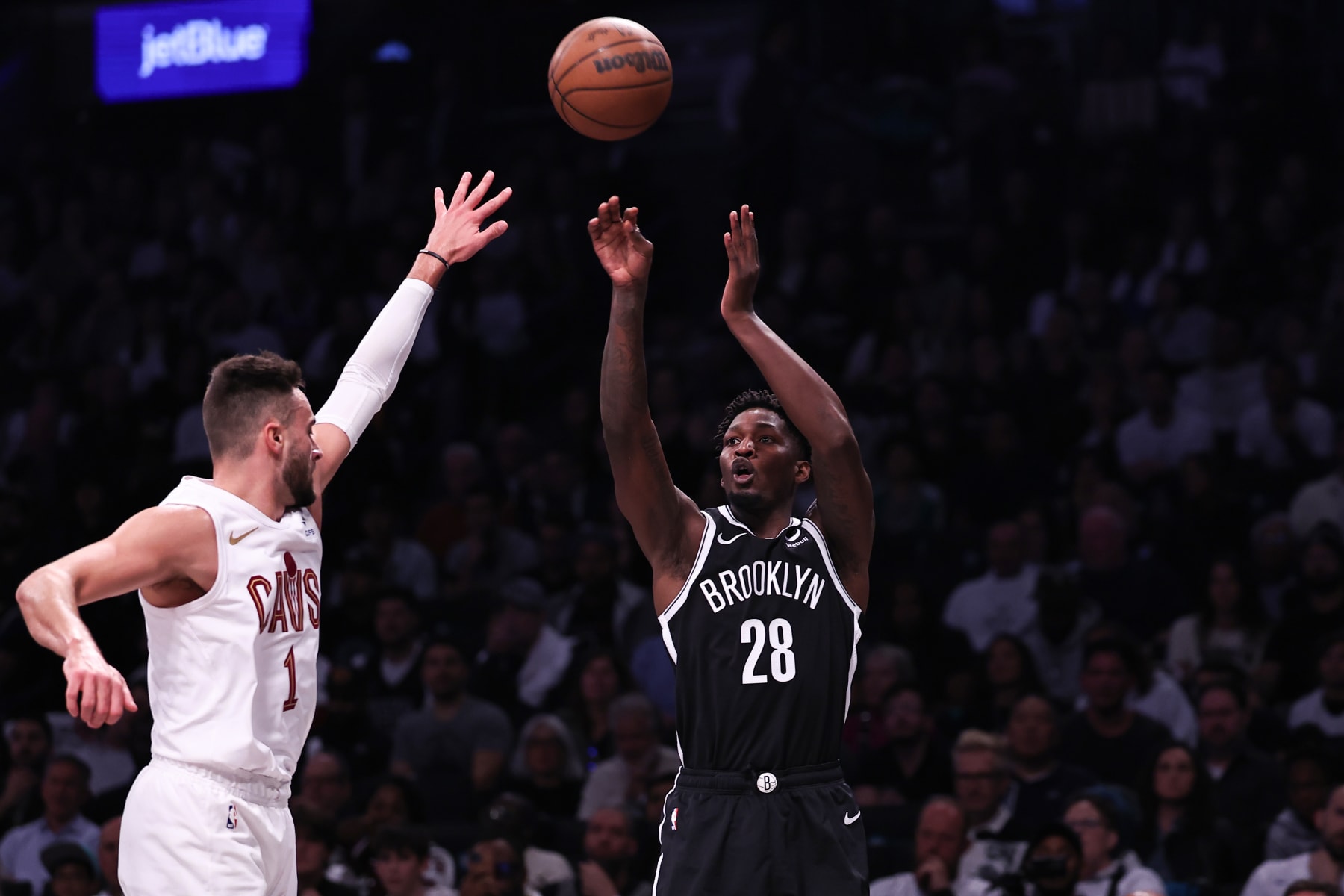 NEW YORK, NEW YORK - OCTOBER 25: Dorian Finney-Smith #28 of the Brooklyn Nets shoots the ball guarded by Max Strus #1 of the Cleveland Cavaliers during the first quarter of the game at Barclays Center on October 25, 2023 in New York City. NOTE TO USER: User expressly acknowledges and agrees that, by downloading and or using this photograph, User is consenting to the terms and conditions of the Getty Images License Agreement. (Photo by Dustin Satloff/Getty Images)