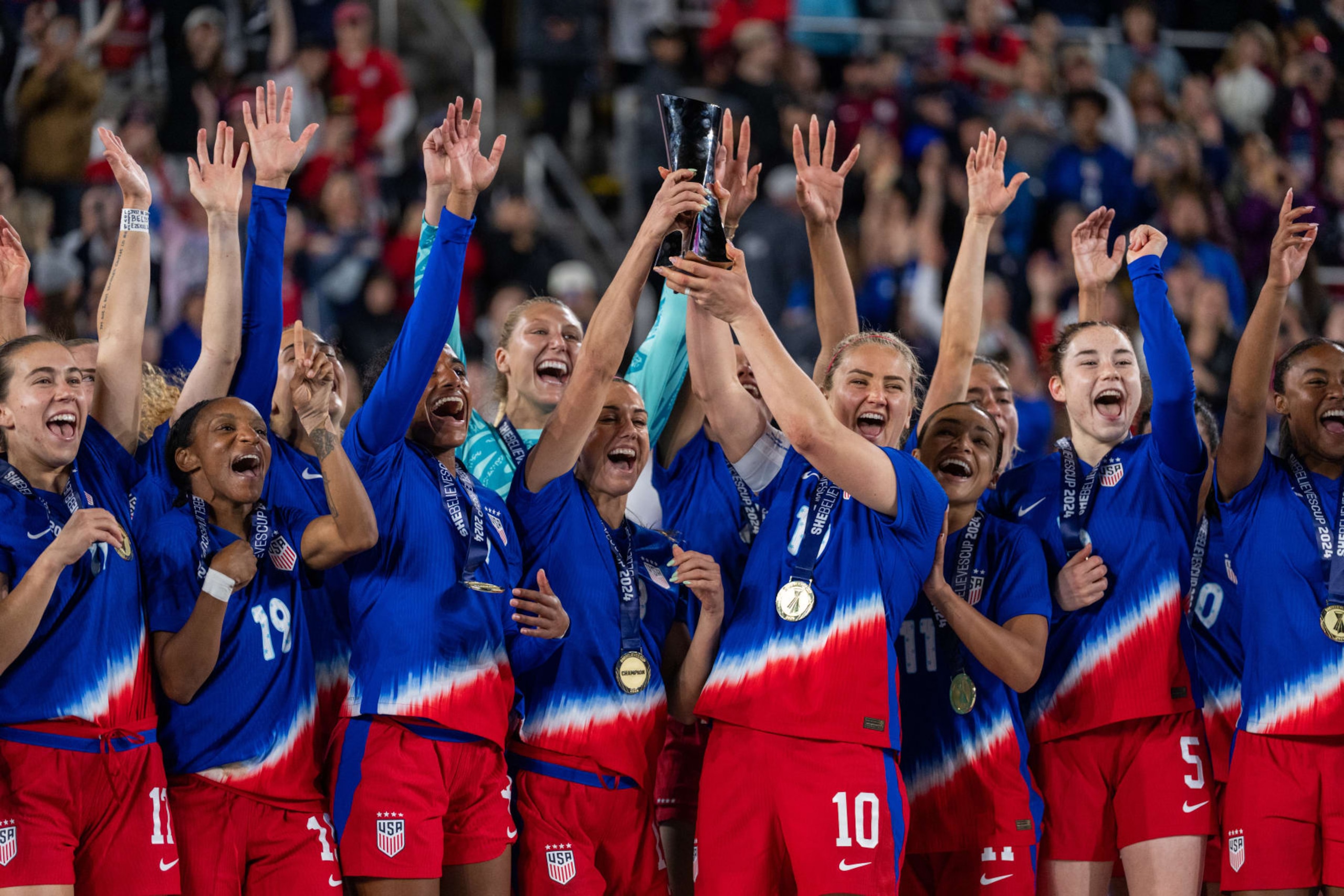 COLUMBUS, OH - APRIL 9: Alex Morgan #13 and Lindsey Horan #10 of the United States raise the SheBelieves Cup trophy after the SheBelieves Cup match between Canada and USWNT at Lower.com Field on April 9, 2024 in Columbus, Ohio. (Photo by Brad Smith/ISI Photos/USSF/Getty Images for USSF)