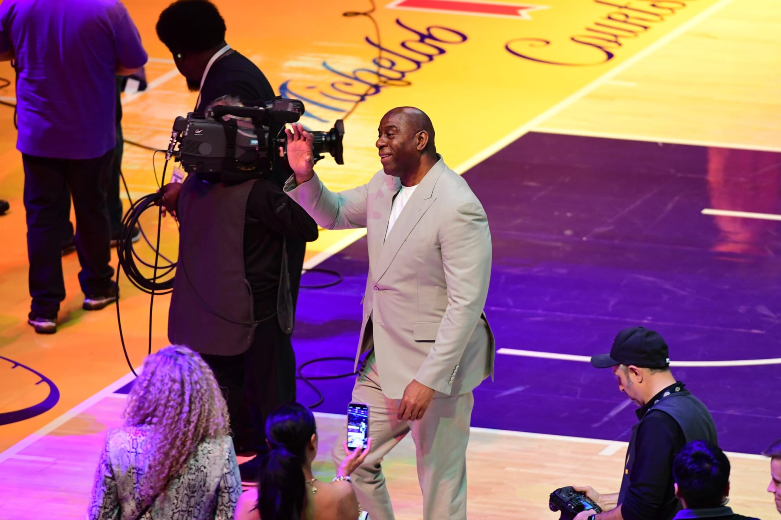 LOS ANGELES, CA - APRIL 25: Magic Johnson waves at halftime during the Denver Nuggets game against the Los Angeles Lakers during Round One Game Three of the 2024 NBA Playoffs on April 25, 2024 at Crypto.Com Arena in Los Angeles, California. NOTE TO USER: User expressly acknowledges and agrees that, by downloading and/or using this Photograph, user is consenting to the terms and conditions of the Getty Images License Agreement. Mandatory Copyright Notice: Copyright 2024 NBAE (Photo by Adam Pantozzi/NBAE via Getty Images)