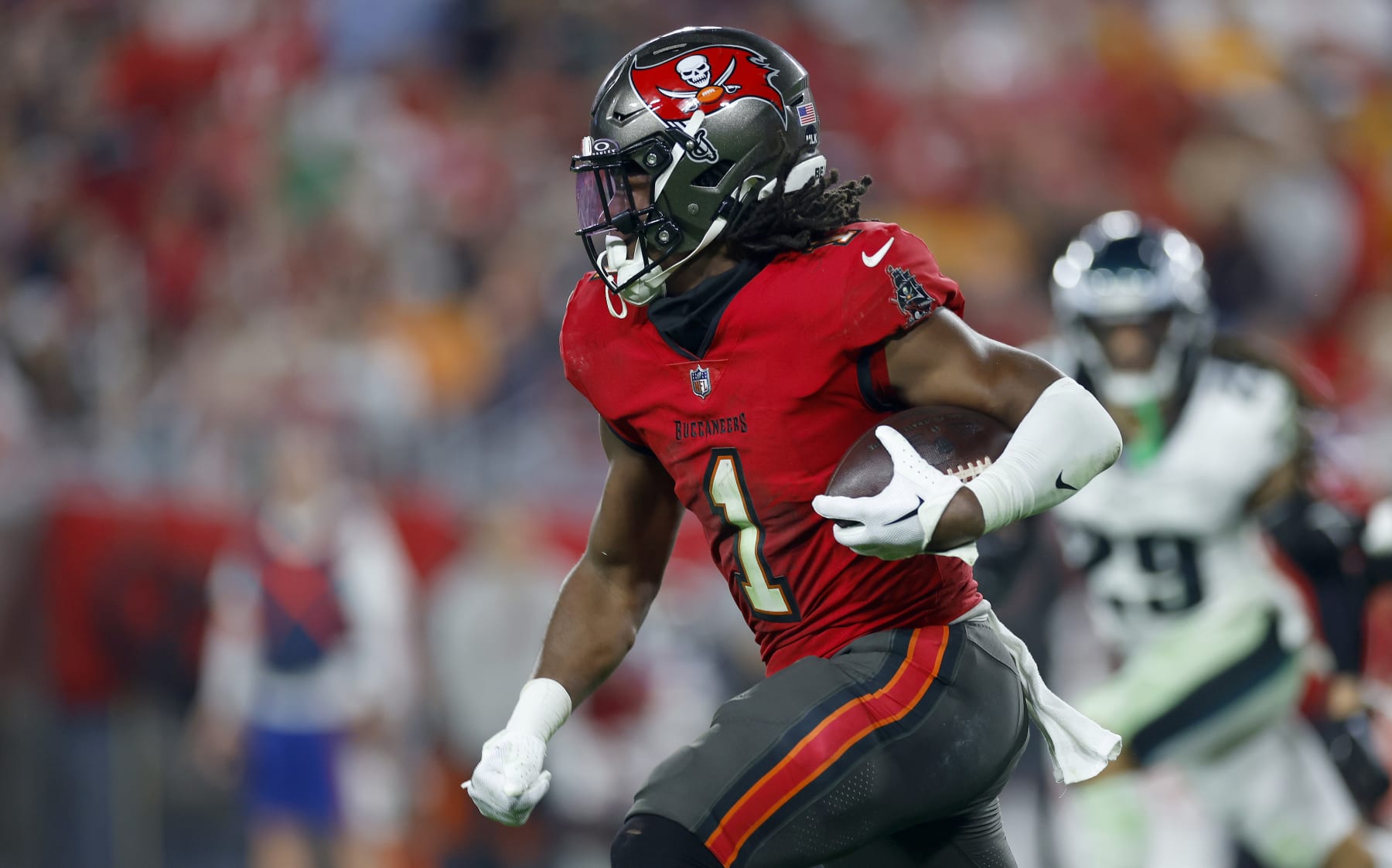TAMPA, FLORIDA - JANUARY 15: Rachaad White #1 of the Tampa Bay Buccaneers rushes during the NFC Wild Card game against the Philadelphia Eagles at Raymond James Stadium on January 15, 2024 in Tampa, Florida. (Photo by Mike Ehrmann/Getty Images)