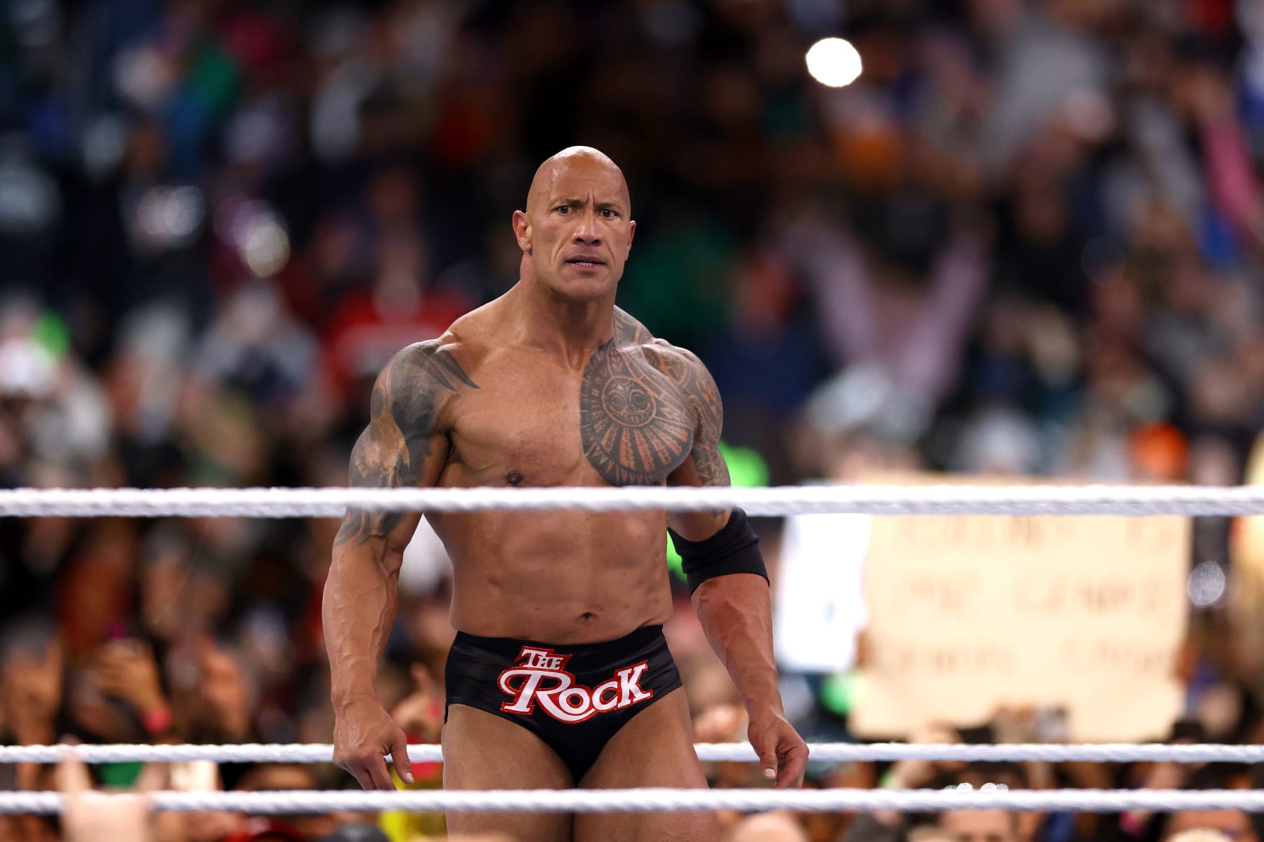 PHILADELPHIA, PENNSYLVANIA - APRIL 06: Dwayne "The Rock" Johnson reacts during a tag team fight against Cody Rhodes and Seth "Freakin" Rollins during Night One of WrestleMania 40 at Lincoln Financial Field on April 06, 2024 in Philadelphia, Pennsylvania.  (Photo by Tim Nwachukwu/Getty Images)