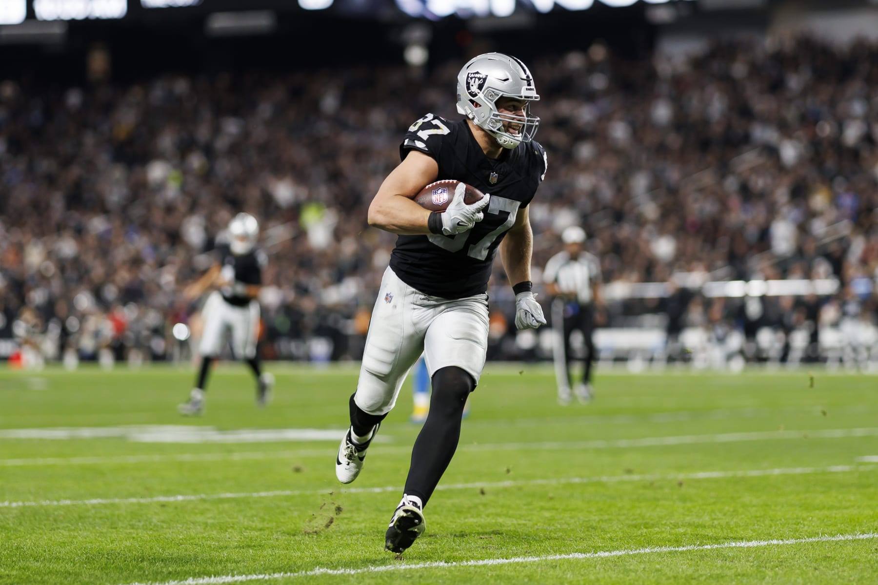 LAS VEGAS, NEVADA - DECEMBER 14: Michael Mayer #87 of the Las Vegas Raiders runs the ball after a catch to score a touchdown during an NFL football game against the Los Angeles Chargers at Allegiant Stadium on December 14, 2023 in Las Vegas, Nevada. (Photo by Ryan Kang/Getty Images)