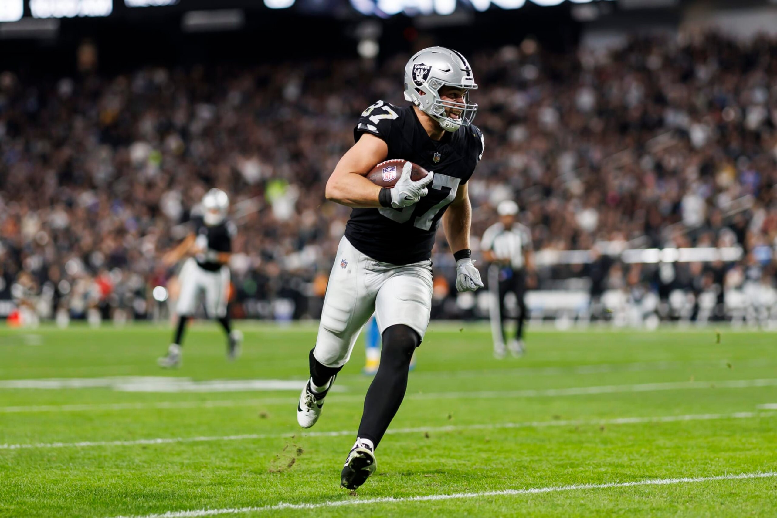 LAS VEGAS, NEVADA - DECEMBER 14: Michael Mayer #87 of the Las Vegas Raiders runs the ball after a catch to score a touchdown during an NFL football game against the Los Angeles Chargers at Allegiant Stadium on December 14, 2023 in Las Vegas, Nevada. (Photo by Ryan Kang/Getty Images) LAS VEGAS, NEVADA - DECEMBER 14: Michael Mayer #87 of the Las Vegas Raiders runs the ball after a catch to score a touchdown during an NFL football game against the Los Angeles Chargers at Allegiant Stadium on December 14, 2023 in Las Vegas, Nevada. (Photo by Ryan Kang/Getty Images)