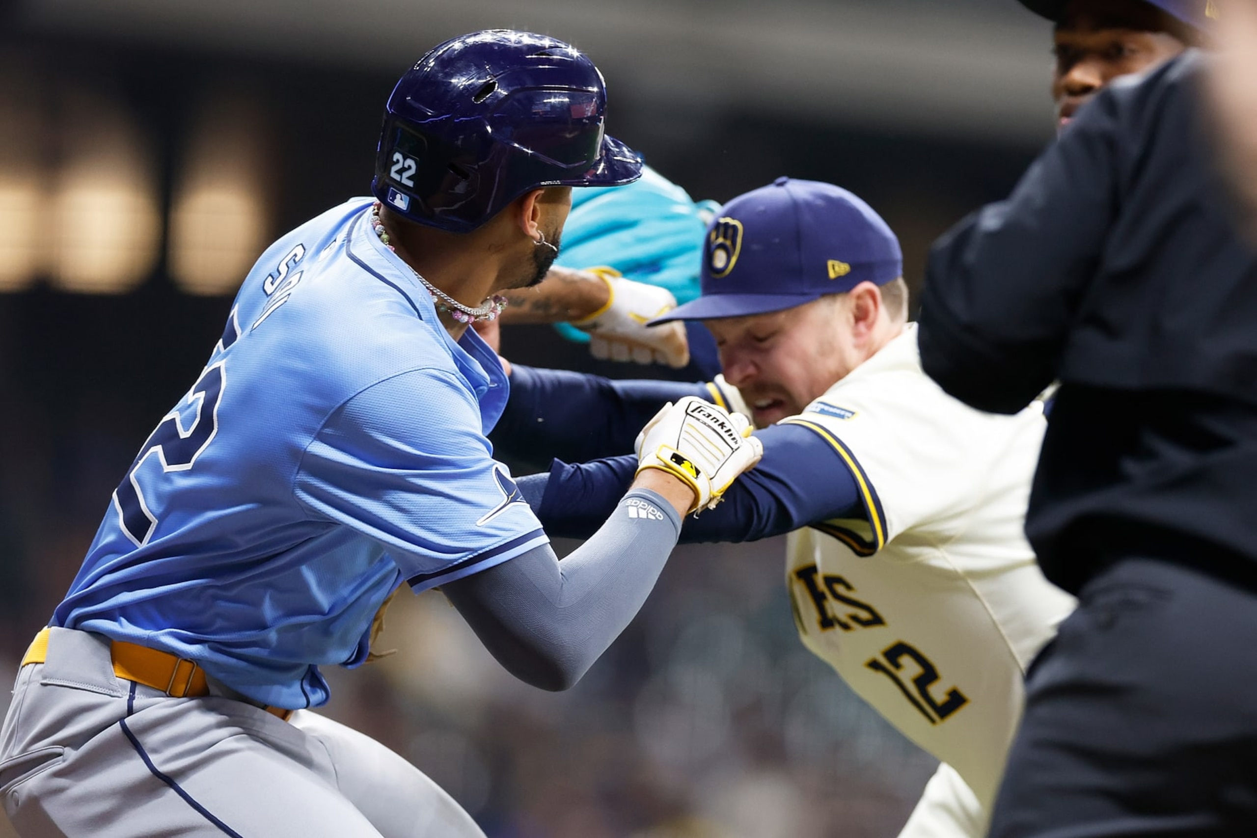 MILWAUKEE, WISCONSIN - APRIL 30: Rhys Hoskins #12 of the Milwaukee Brewers holds back Jose Siri #22 of the Tampa Bay Rays who attempts to go after pitcher Abner Uribe #45 of the Milwaukee Brewers in the eighth inning at American Family Field on April 30, 2024 in Milwaukee, Wisconsin. (Photo by John Fisher/Getty Images)