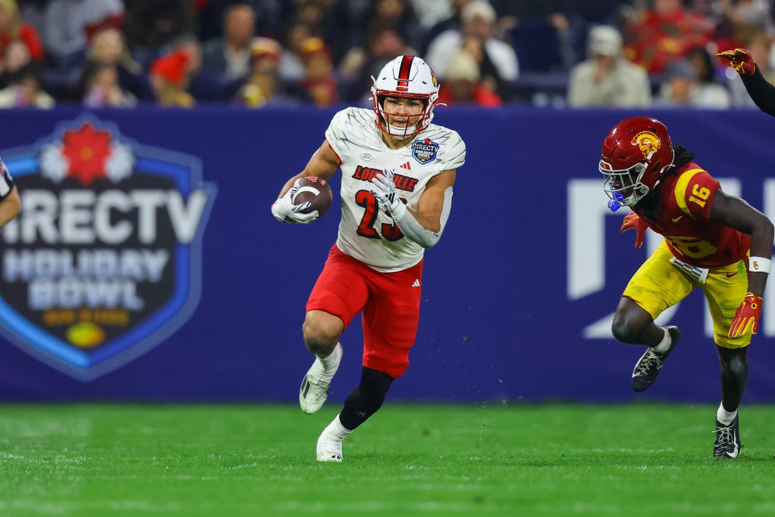 SAN DIEGO, CA - DECEMBER 27: Louisville Cardinals running back Isaac Guerendo (23) runs the ball for a gain during the Directv Holiday Bowl football game between the Louisville Cardinals and the USC Trojans on December 27, 2023, at Petco Park in San Diego, CA. (Photo by Jordon Kelly/Icon Sportswire via Getty Images)