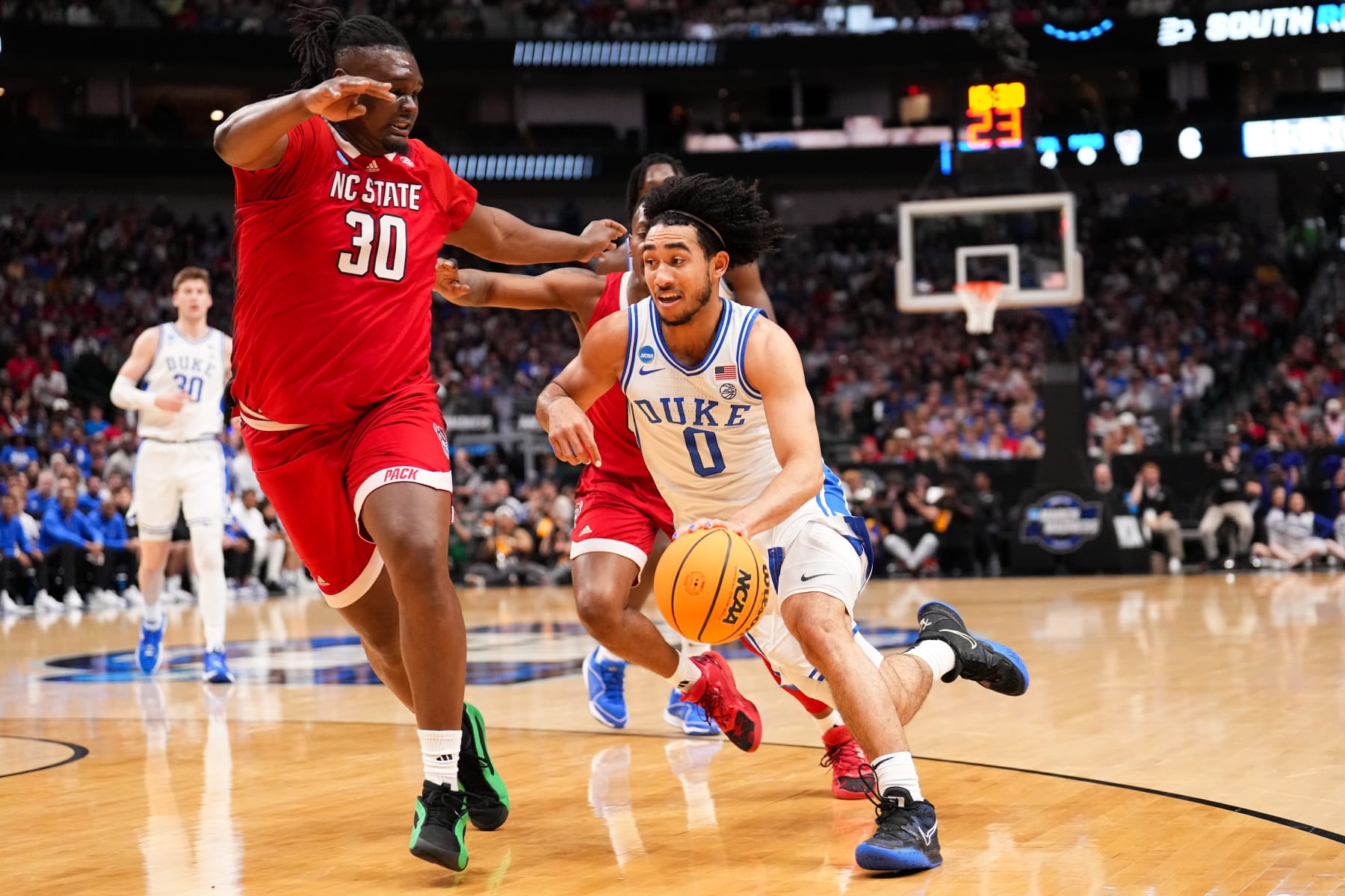 DALLAS, TEXAS - MARCH 31: Jared McCain #0 of the Duke Blue Devils looks to drive in a game against the North Carolina State Wolfpack during the Elite Eight round of the 2024 NCAA Men's Basketball Tournament held at American Airlines Center on March 31, 2024 in Dallas, Texas. (Photo by Jack Dempsey/NCAA Photos via Getty Images)